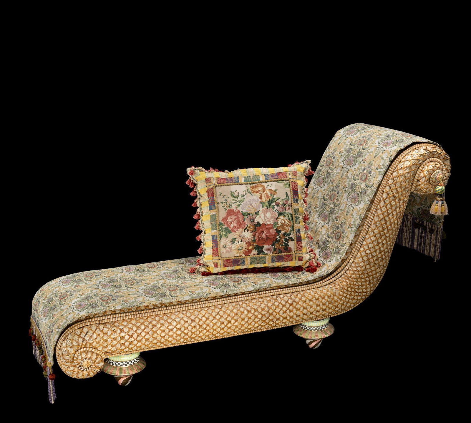 MacKenzie Childs Rattan Chaise Lounge: NOT ELIGIBLE FOR IN-HOUSE SHIPPING. DESCRIPTION: A late 20th Century example of the MacKenzie Childs chaise lounge, rattan construction and with the colorful ceramic Taylor legs found on earlier piece