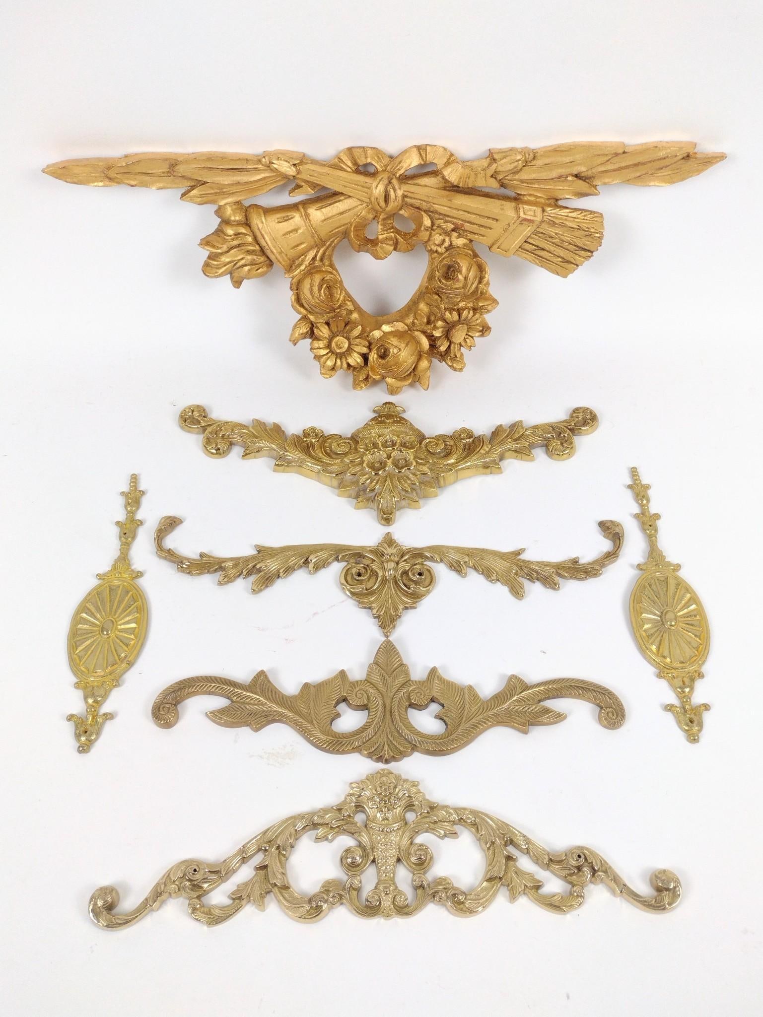 7 Wall Hanging Frame Embellishments: One made of wood and 6 made of brass. 2-1/2" to 22-3/4" wide. 4-1/2" to 9" high.