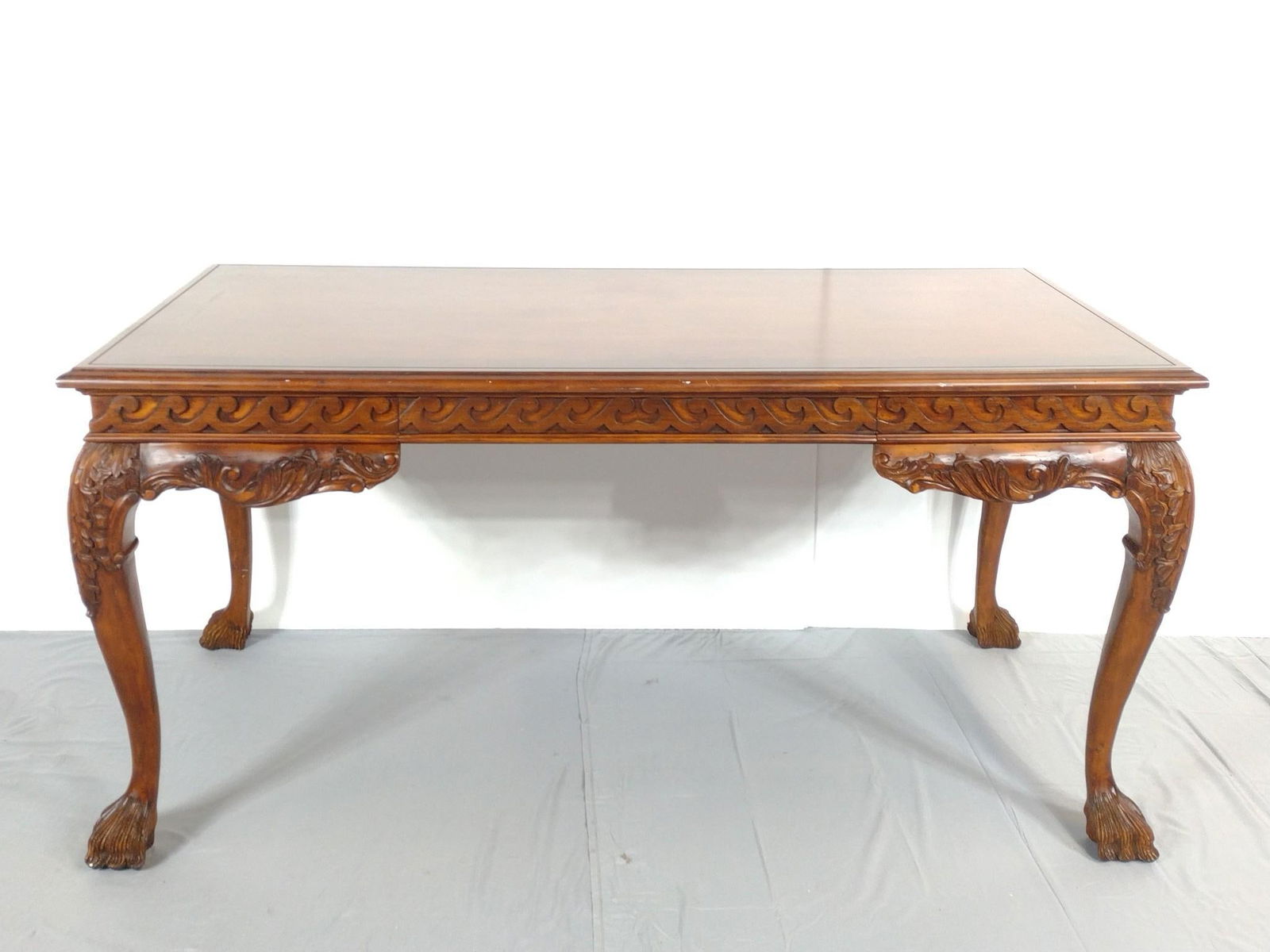 Carved Library Table: NOT ELIGIBLE FOR IN-HOUSE SHIPPING. 60" wide X 31" deep X 30" high. Has a few light scratches. No manufactures name found.