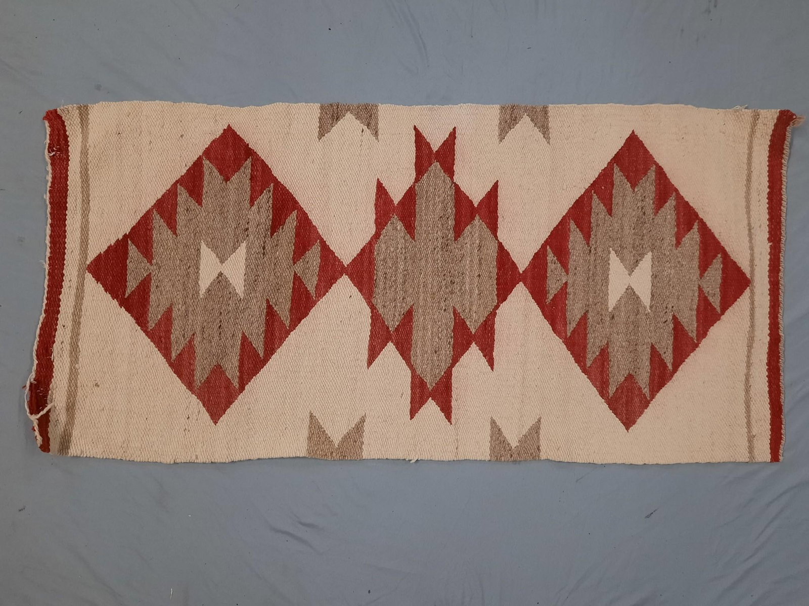 Navajo Eye Dazzler Scatter Rug: Bleeding of colors. 18-3/4" wide x 38" long.