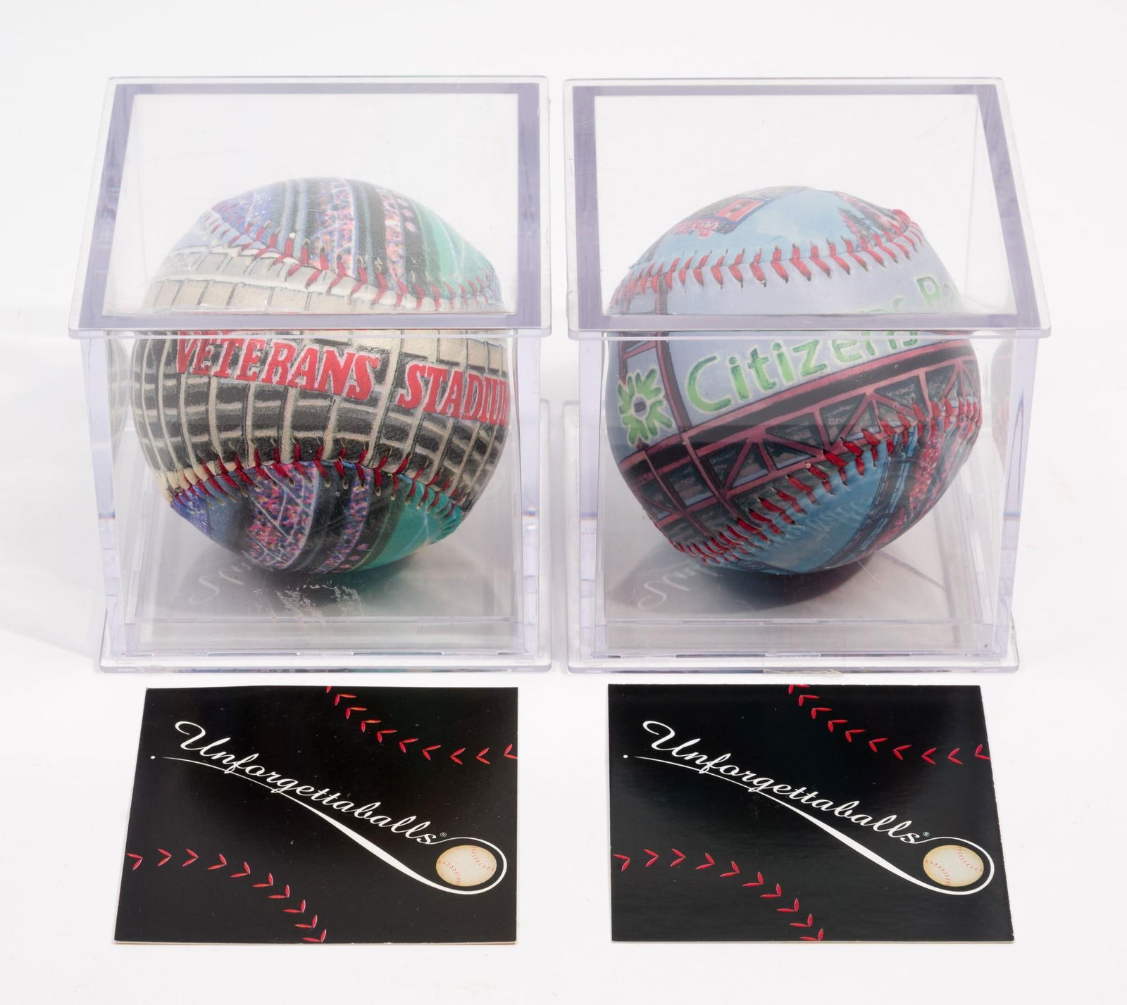 2 Commemorative Stadium Printed Baseballs in Cases: Includes Veterans Stadium and Citizens Bank Park designs. Both designed by Emily Wolfson. Both with certificate of authenticity. Each ball is a limited edition printing of 75,000 pieces. Overall with