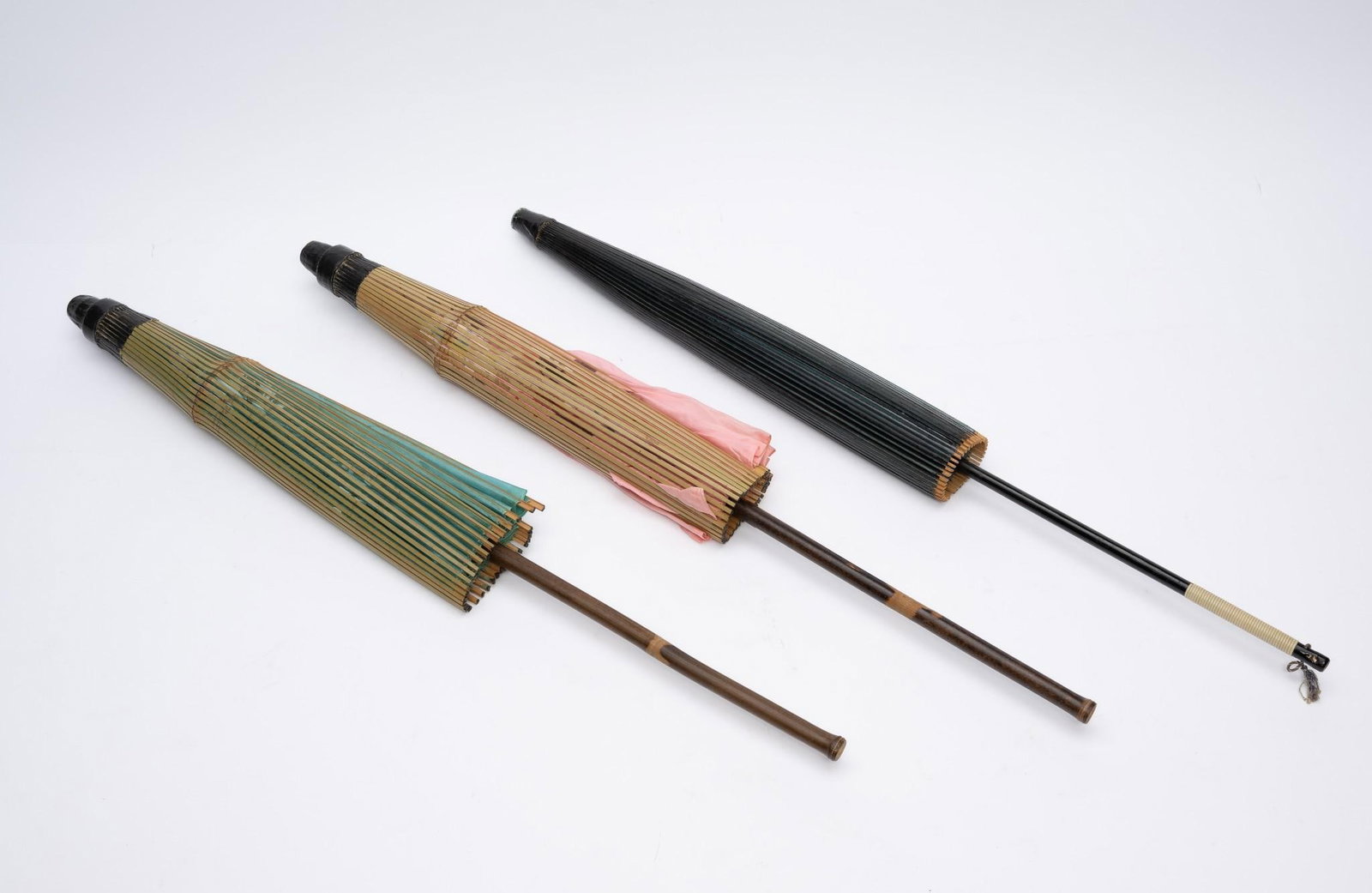 3 Asian Parasols: Includes 2 silk and 1 paper. 27" to 27-1/2" long. Small hole in pink parasol.