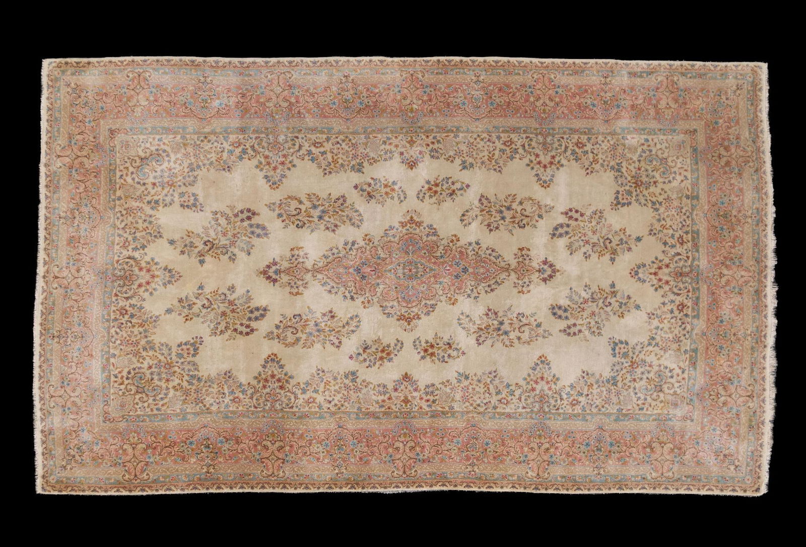 Iran Wool Oriental Room Size Rug: NOT ELIGIBLE FOR IN-HOUSE SHIPPING. Cream background with floral motifs in center. Tag on the back very faded, marked Iran. 10' wide x 16' 6" long. Fading consistent with age and use.