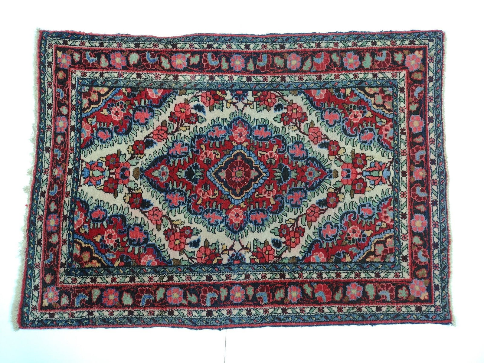 Antique Area Rug with Rosette Motif and Center Medallion: NOT ELIGIBLE FOR IN-HOUSE SHIPPING. 4'11" long X 3'5" wide. Some wear consistent with age and use.