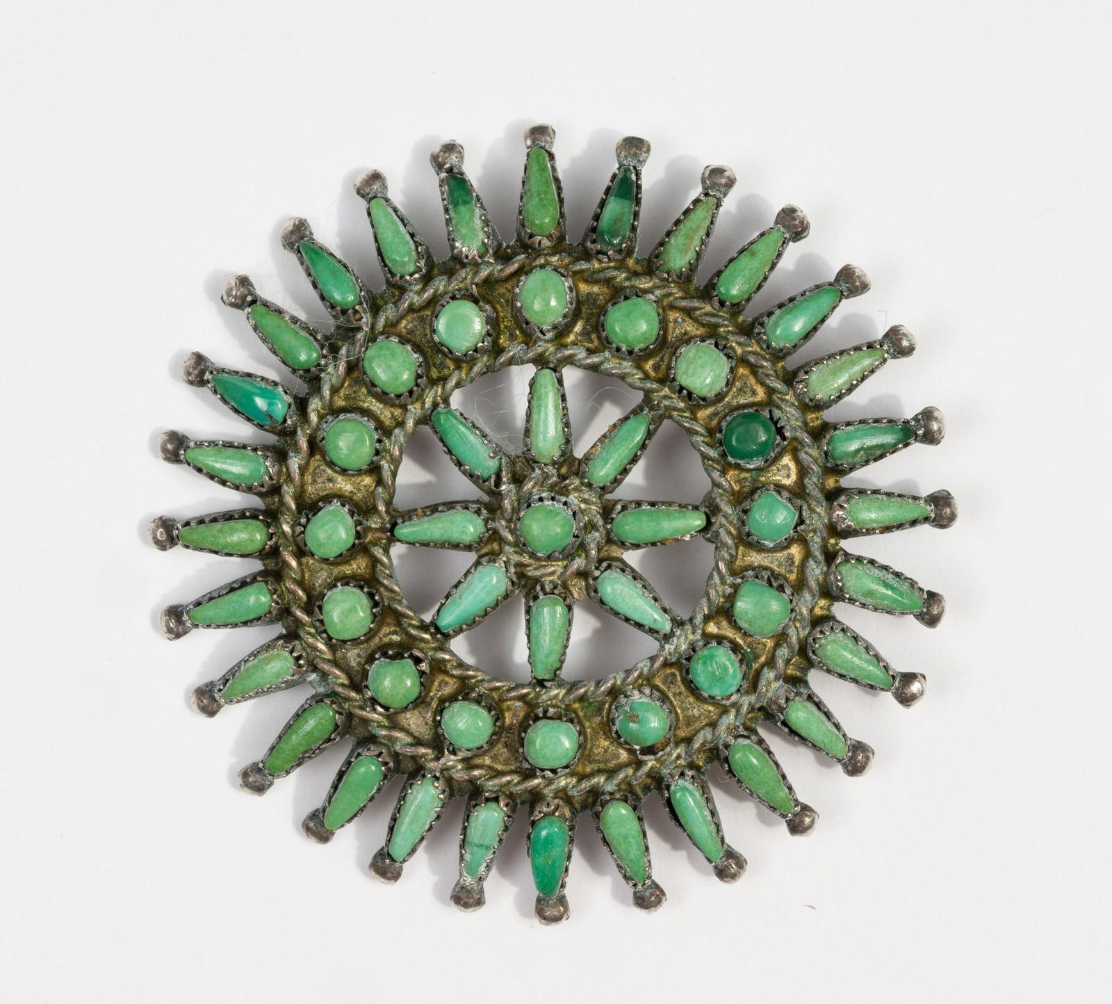 Zuni Needlepoint Turquoise Sterling Silver Pendant: A convertible brooch pendant by Zuni silver artist Joanne Cheama. Weight is 0.3 troy ounces. Diameter is 1 3/4".