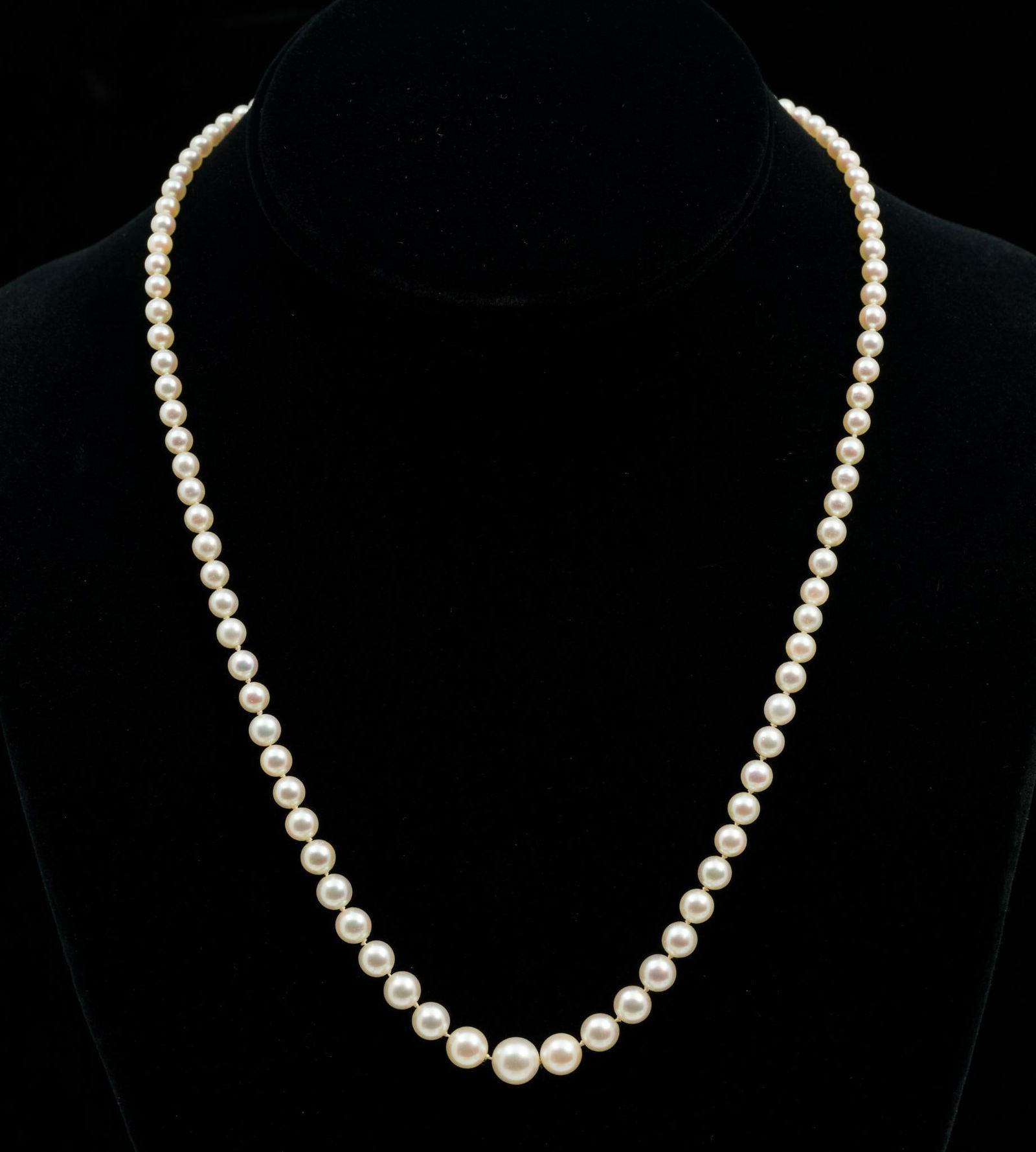 Mikimoto Pearl Necklace w/ Silver Clasp: Individually knotted strand of graduated pearls, 3mm to 7.4mm. Silver clasp with inset pearl. 19" long. Includes original case and guarantee from purchase at Lane, Crawford's, Hong Kong. Light wear to