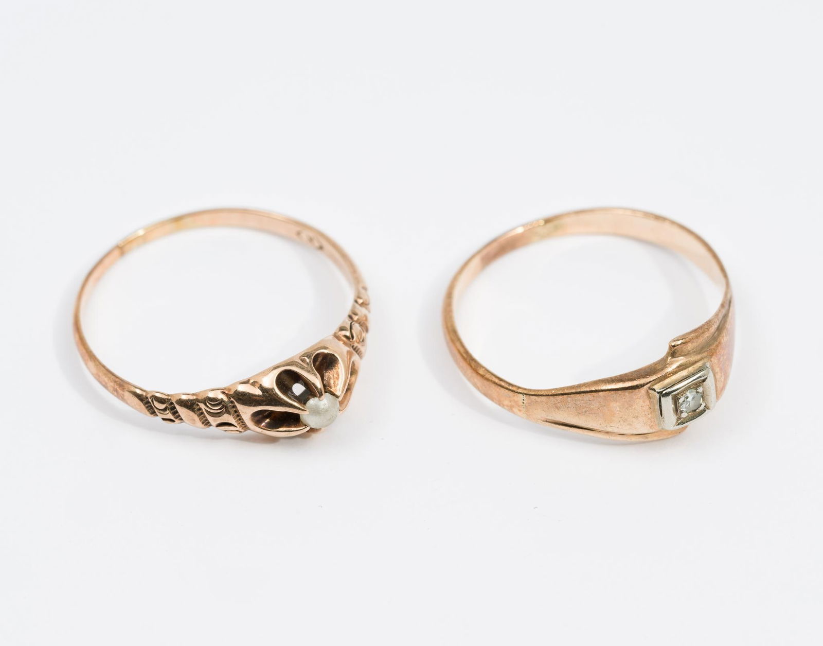 Two 10K Gold Antique Rings: Both marked 10k, one with small diamond (size 6) and one with worn seed pearl (size 6-1/2). Total weight 3.1 grams.