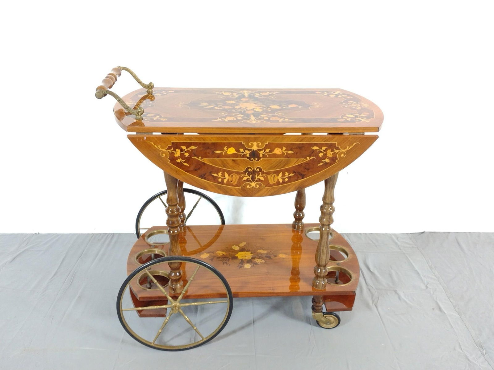 Inlaid Tea Cart: NOT ELIGIBLE FOR IN-HOUSE SHIPPING. Open 29-1/2", closed 17" wide X 29-1/2" deep X 27" high. Has some scratches and finish loss. Top has small spot of veneer loss. Made in Italy. No manufactures name