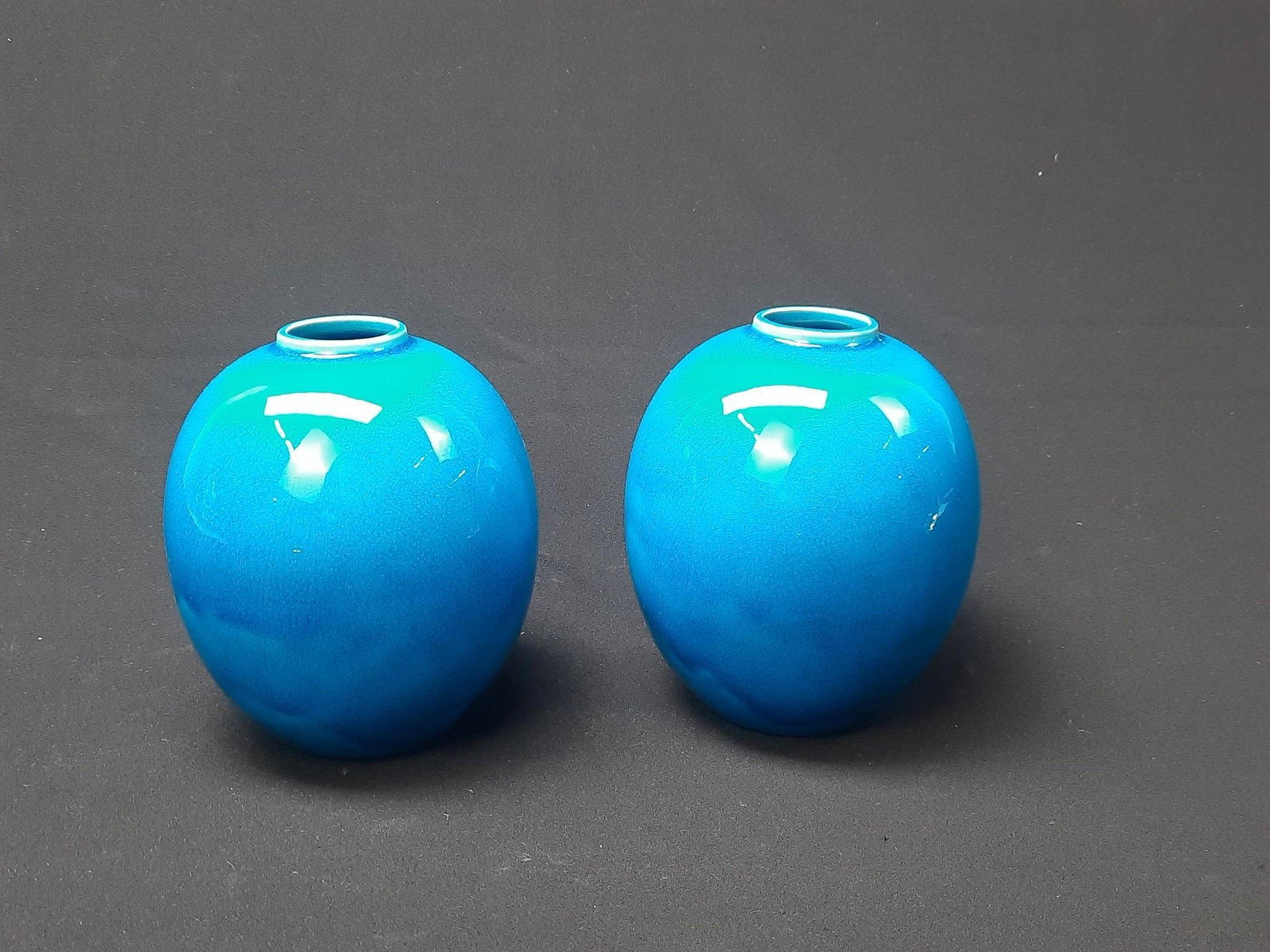 2 Cowan Turquoise Vases: Both signed. 5" diameter x 6-1/4" high. Some staining.