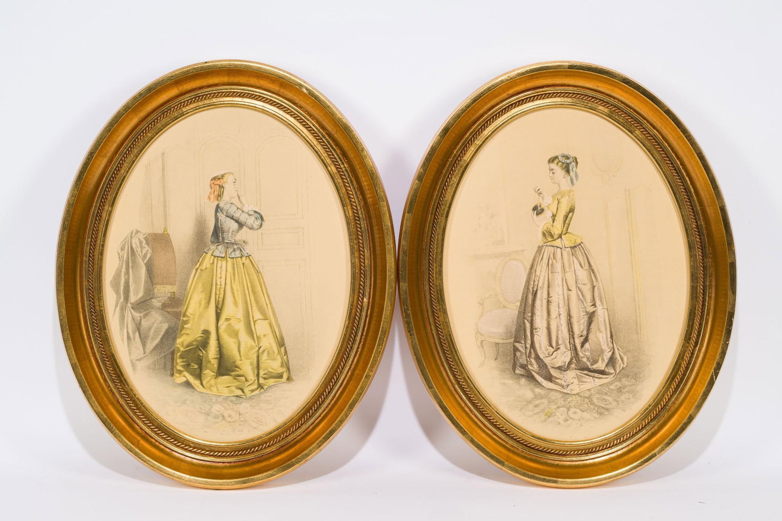 Pr Antique Victorian Lady Fashion Prints: NOT ELIGIBLE FOR IN-HOUSE SHIPPING. Each sight: 11" high x 5-1/4" wide. Overall with frame: 19-1/2" high x 15-1/2" wide.
