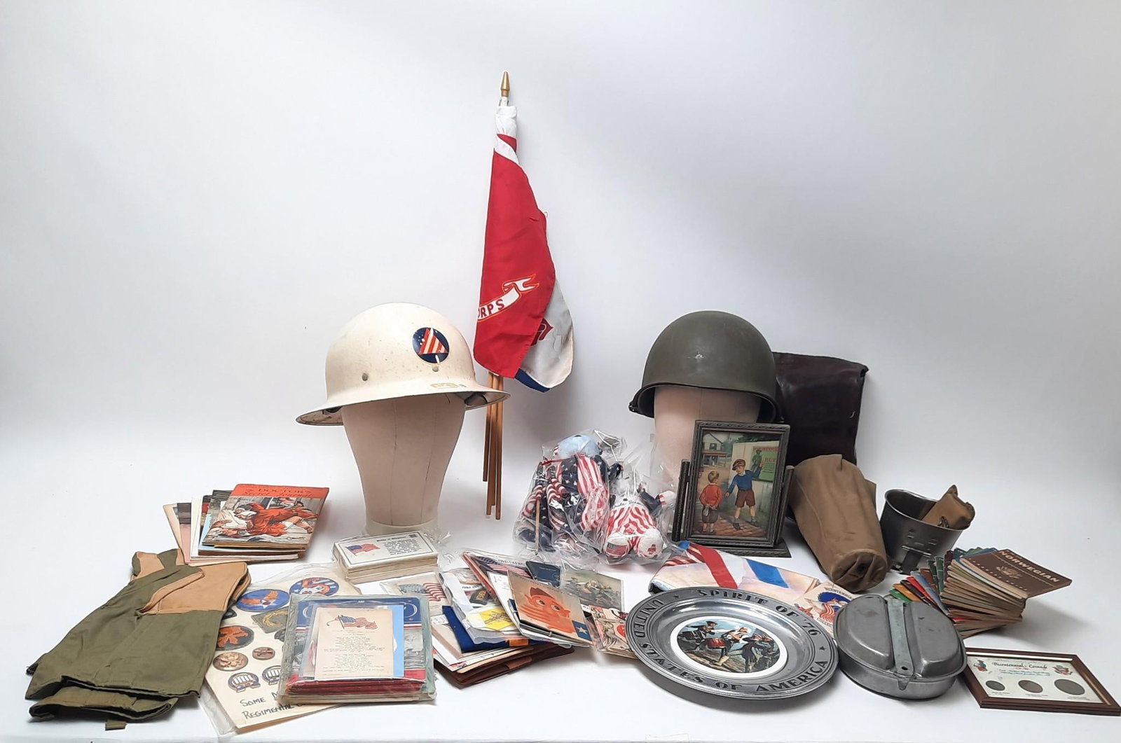 Grouping of Military Items incl Ration Books, Helmets, and Ephemera: NOT ELIGIBLE FOR IN-HOUSE SHIPPING. Larger helmet approximately 13" x 12" x 7".