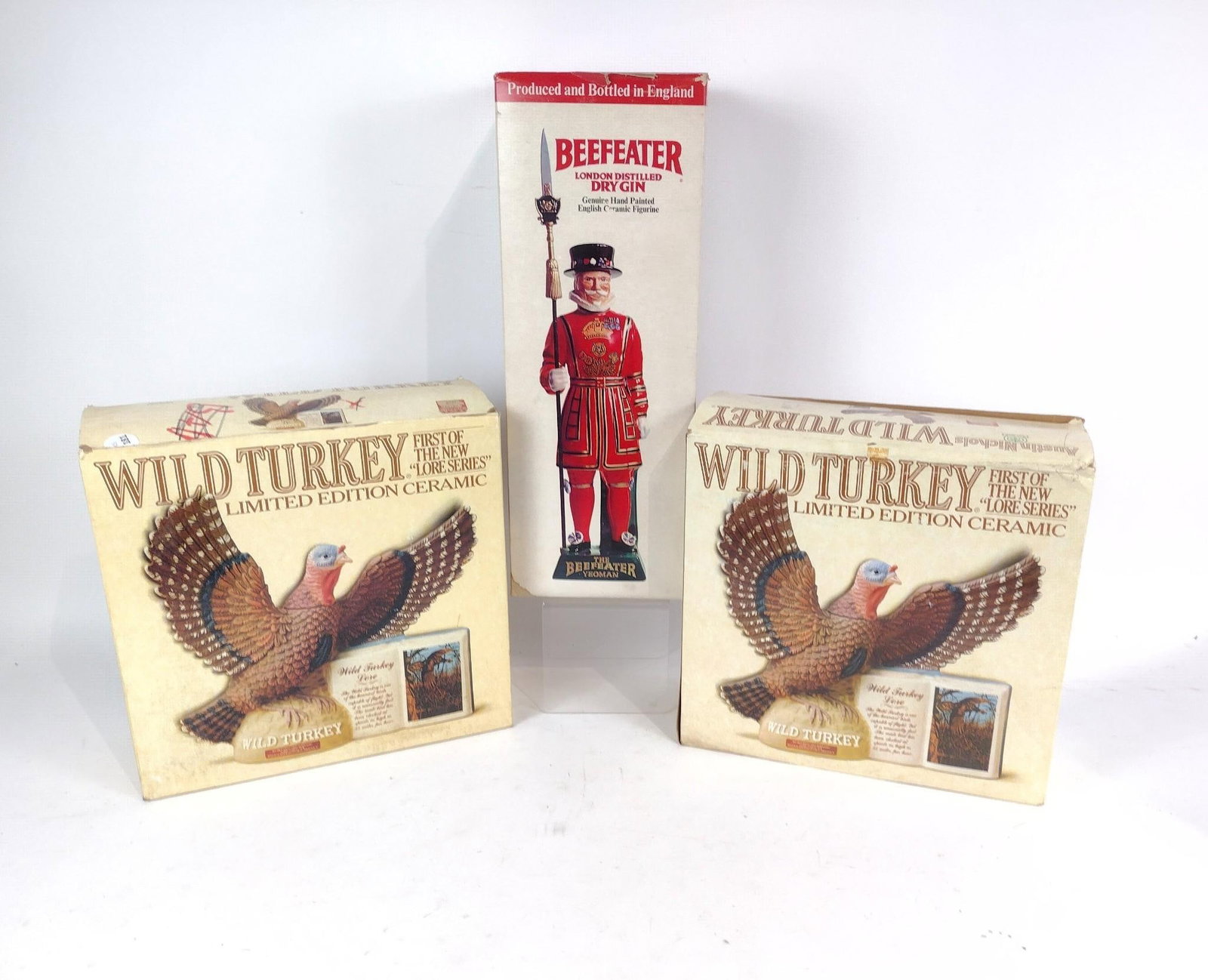 2 Wild Turkey Ceramic Figures & Beefeater Ceramic Figurine in OBs: NOT ELIGIBLE FOR IN-HOUSE SHIPPING. 5-1/4" to 5-1/2" wide x 12-3/4" to 19" long.