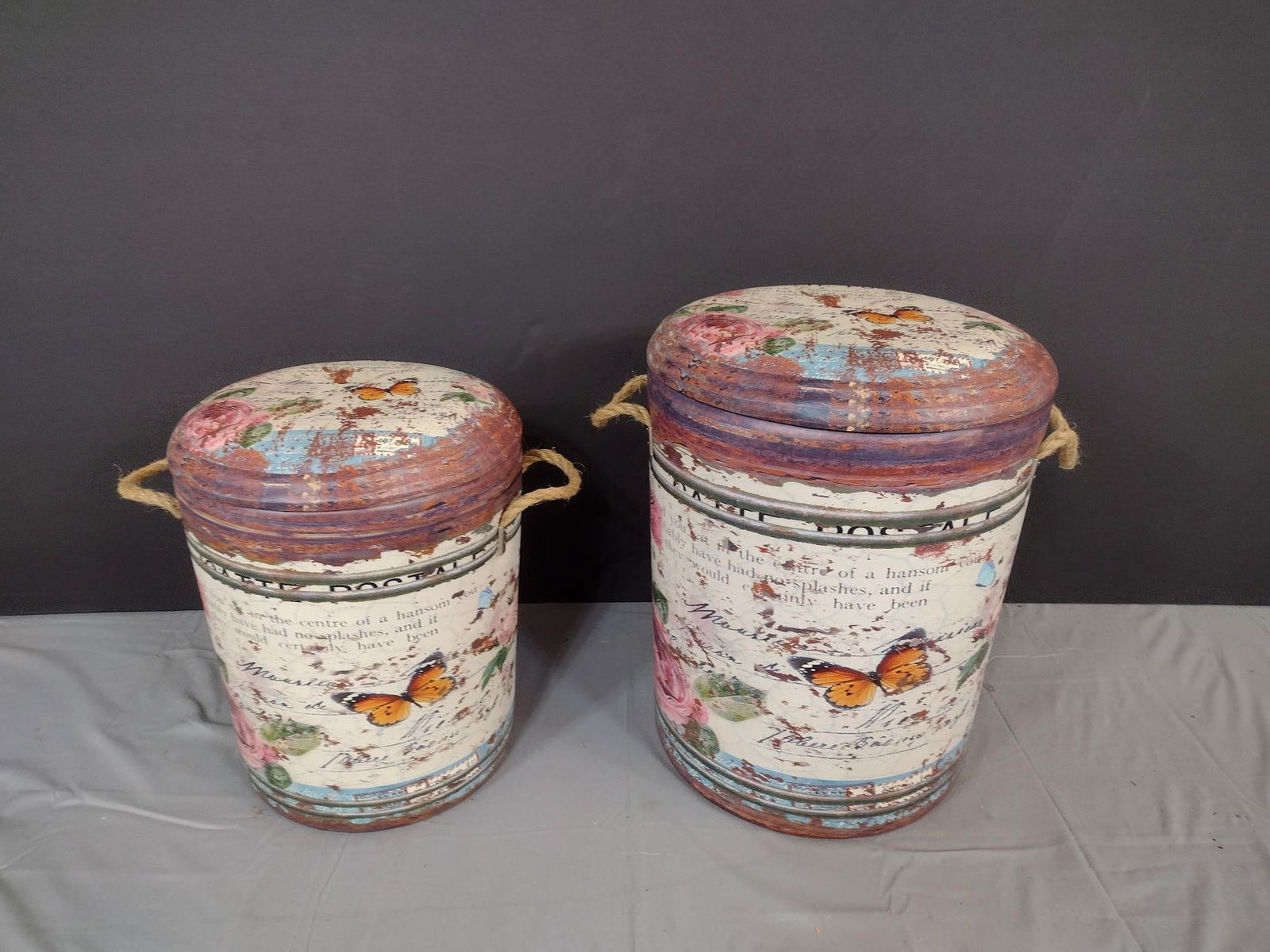 2 Butterfly/Rose Decorative Boxes: NOT ELIGIBLE FOR IN-HOUSE SHIPPING. Rope handles. 12" to 15" diameter x 15" to 17" high.