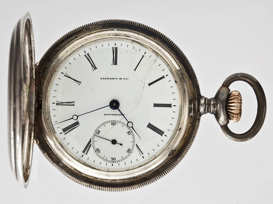 935 Silver Tiffany Longines Pocketwatch: DESCRIPTION: Tiffany Longines pocketwatch. Hunting case, stem wound, lever set. Porcelain single sunk dial with subsidiary seconds, Roman numerals, marked "Tiffany & Co. Switzerland". Marked .935 ster