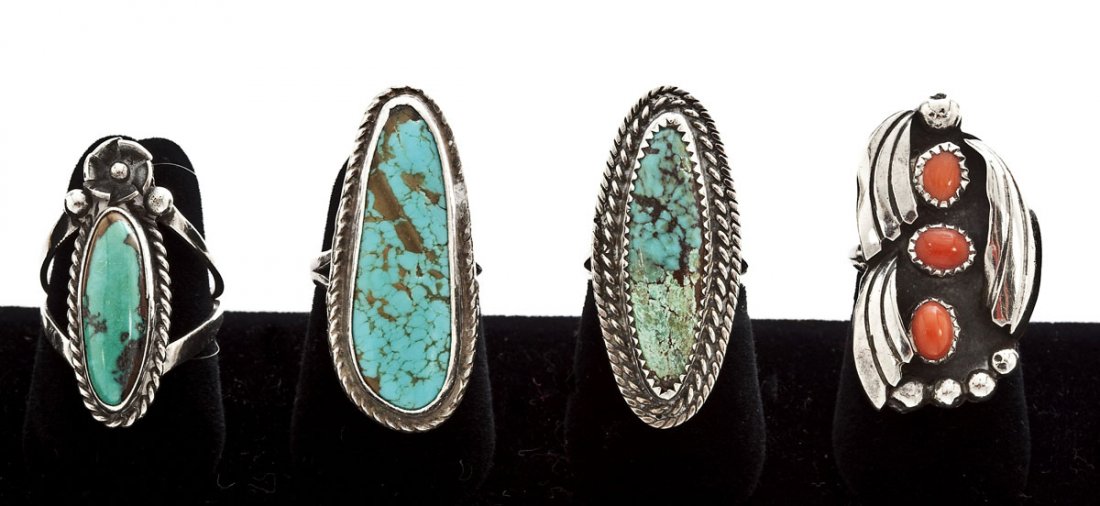 4 Navajo Silver & Stone Rings: DESCRIPTION: Four Navajo silver and stone rings. Includes: 1) Ring with oval turquoise central stone and carved decoration. Size 8. 2) Ring with three carnelian stones and an applied design. Size 5. 3