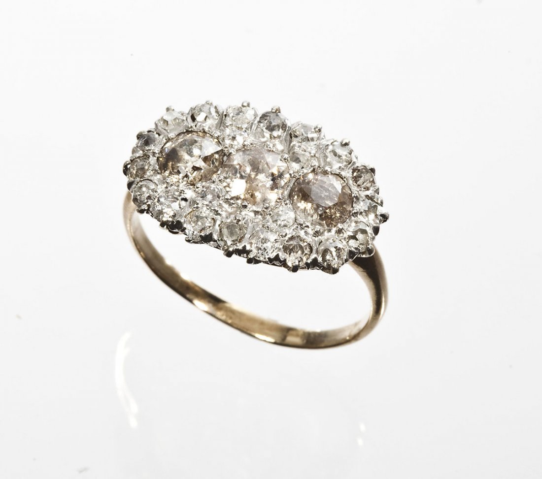 1.74 CTW Diamond Ring: DESCRIPTION: Diamond ring in marked marked 14K yellow and white gold. Set with three approximately .35 carat Old European cut diamonds. Color I3. Surrounded by twenty-two approximately 3 to 5 point Ol