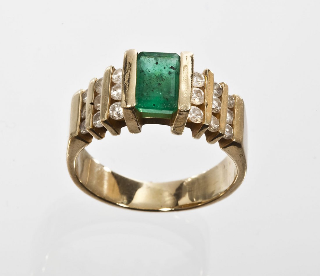 .75 Ct Emerald & .54 CTW Diamond Ring: DESCRIPTION: Emerald and diamond ring in marked 14k yellow gold. Set with one approximately 7mm x 4mm .75 carat emerald cut emerald and eighteen round diamonds (six approximately 2-1/2 point, six appr