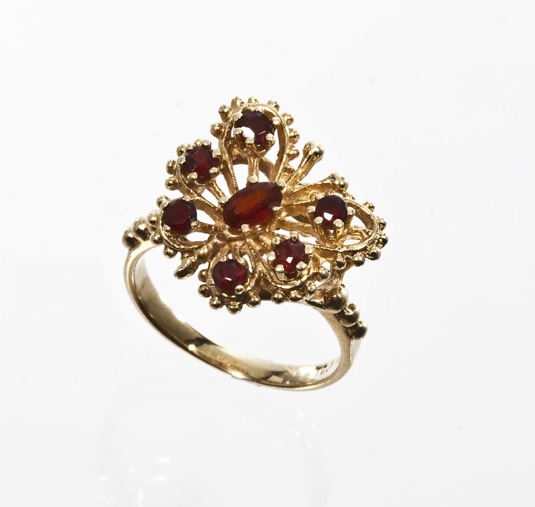 14K Gold & Garnet Butterfly Ring: DESCRIPTION: Garnet butterfly ring in marked 14K yellow gold. Set with seven garnets (one approximately 5mm x 3mm oval and six round from 2mm to 3mm). Size 6-1/2. 2.6 dwt (4.0 gr).