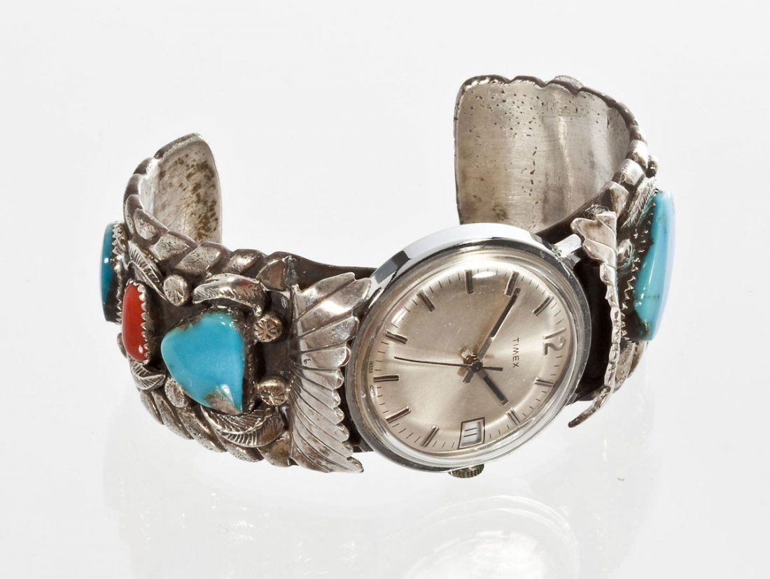 Men's Navajo Wristwatch Cuff: DESCRIPTION: Men's Navajo wristwatch cuff bracelet with four turquoise stones and two carnelian stones. With an applied leaf design. 1-1/4" wide band. Opening 2-1/2" x 1-5/8".