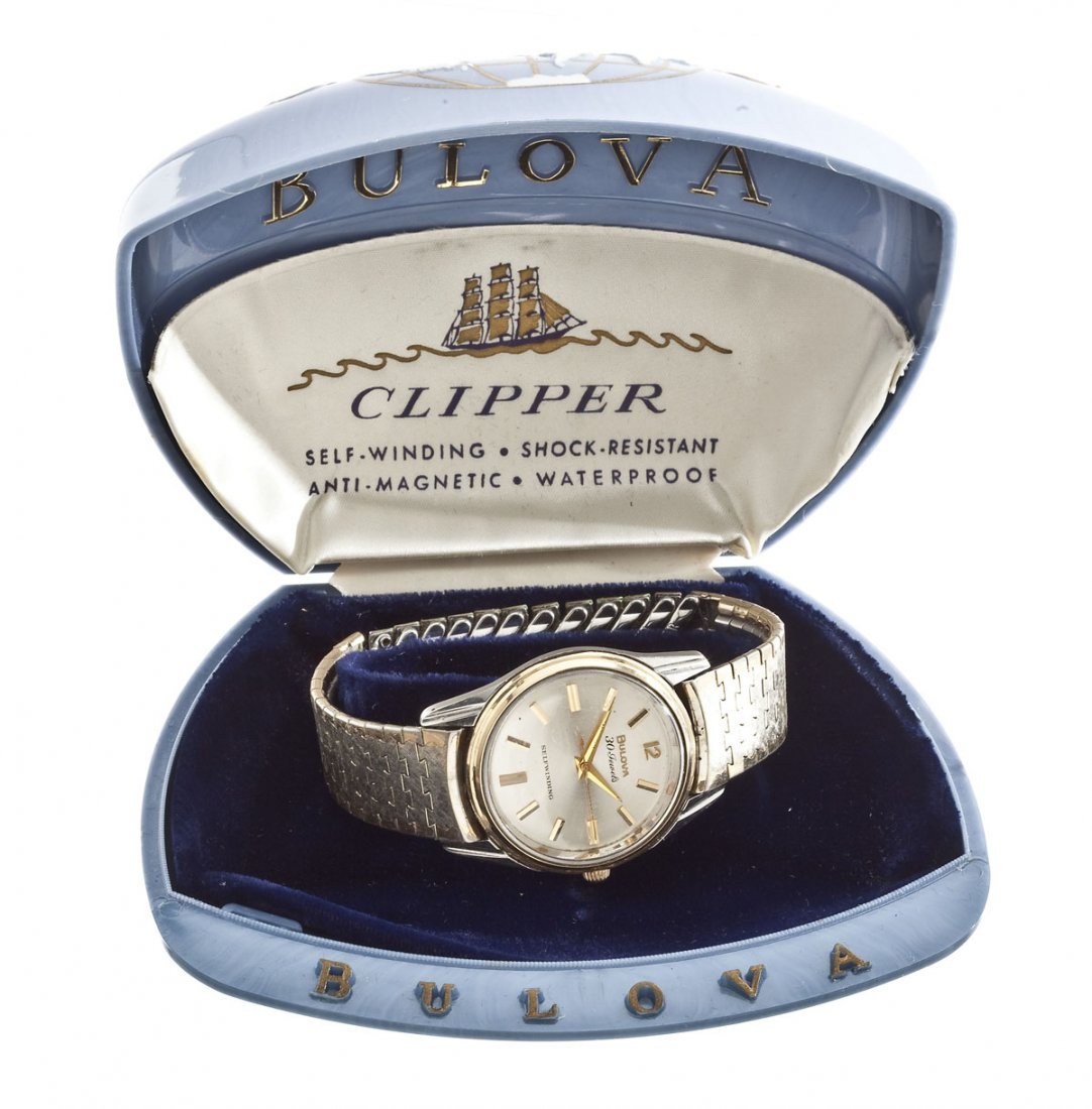 Bulova Clipper Wristwatch in Original Box: DESCRIPTION: Bulova 30 jewel Clipper wristwatch. Silvered dial with sweep seconds, gold numeral markers, marked "Bulova 30 Jewels Selfwinding". Back cover marked "Bulova 14Kt Bezel S.S. Back Shock Res