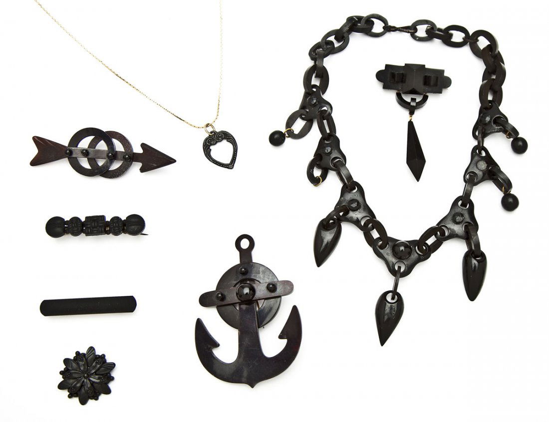 Group of 8 Pcs Mourning Jewelry: DESCRIPTION: Group of eight pieces of mourning jewelry. Including: 1) Jet necklace with large lines, chain link, and teardrop pendants. 19th century. 10" long. 2) Jet pin with crystal shaped pendant.
