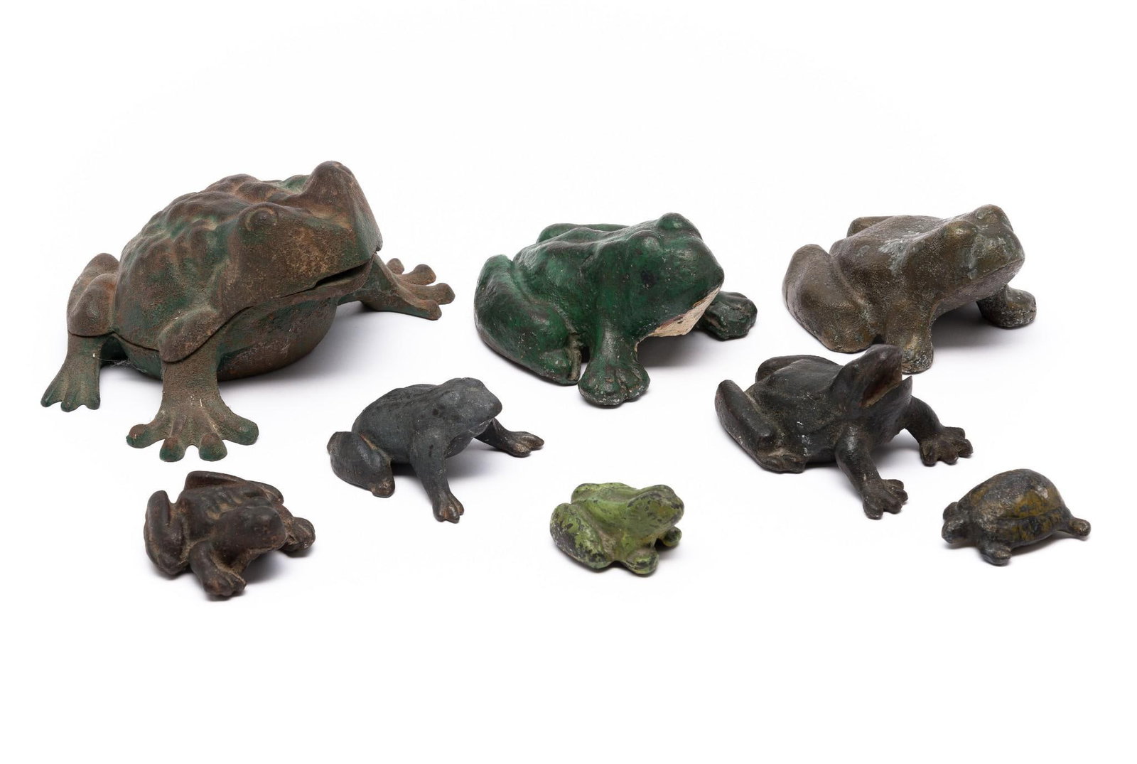 7 Cast Iron Frogs and Turtle: All with general wear consistent with age. 2-1/2" to 5" long.