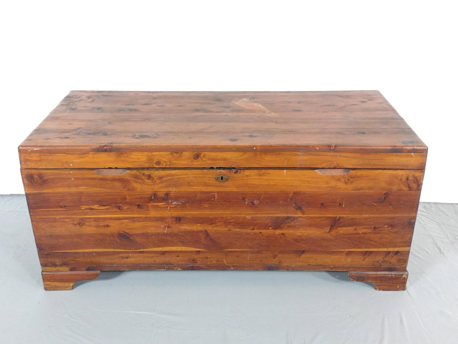 Cedar Chest: NOT ELIGIBLE FOR IN-HOUSE SHIPPING. 47" wide X 22" deep X 20-1/2" high. Top has split. Has some scratches.