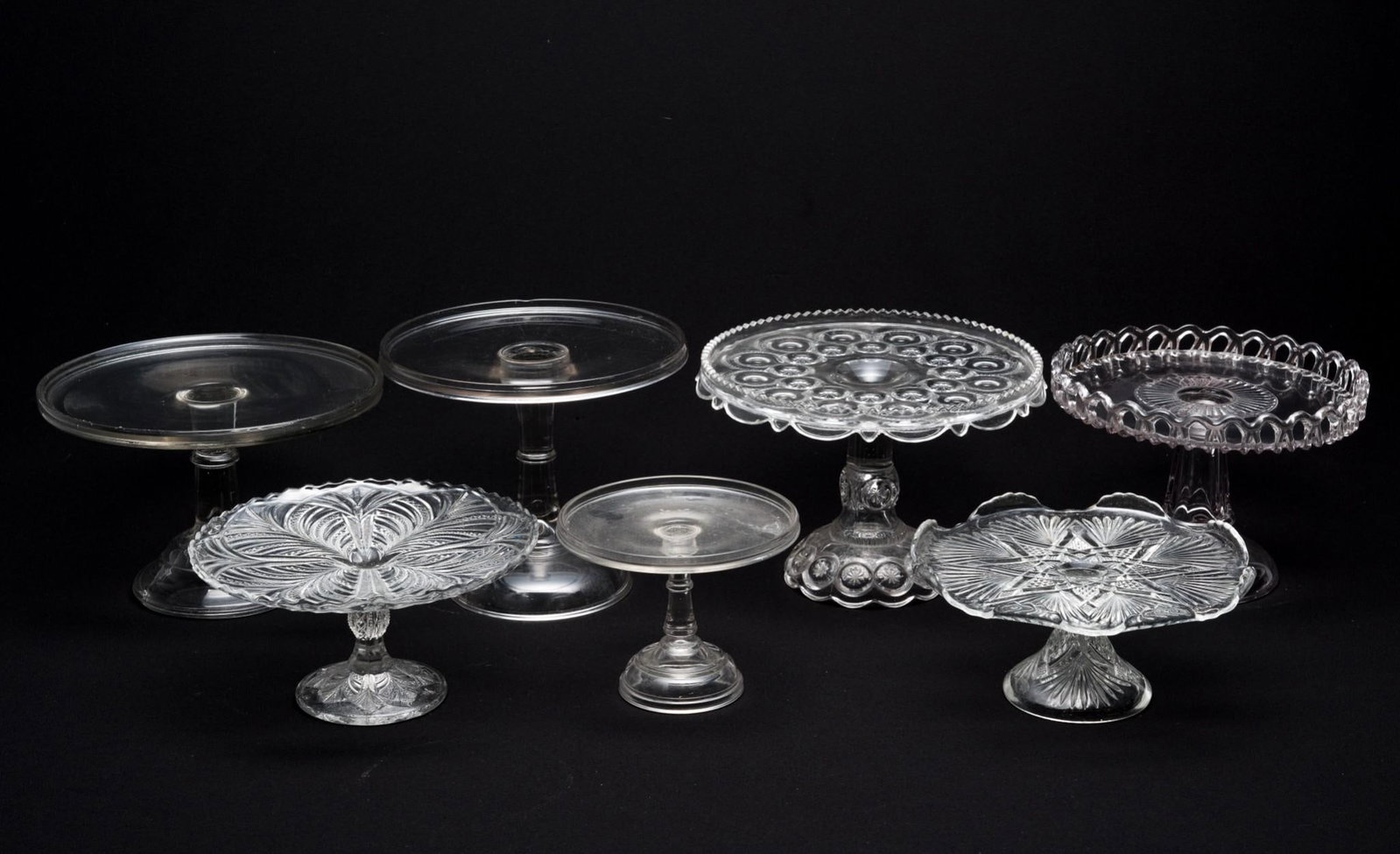 7 Glass Cake Stands: 6-1/2" to 9" wide x 5" to 7-3/4" high.