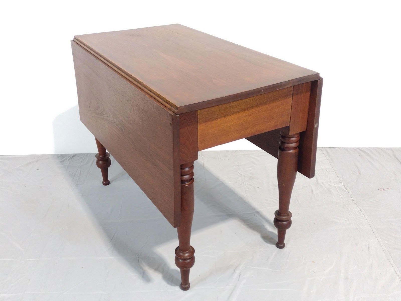 Drop Leaf Table: NOT ELIGIBLE FOR IN-HOUSE SHIPPING. Open 49-1/2", closed 21-1/2" wide X 38" deep X 29" high. Has some scratches and areas of discoloration.