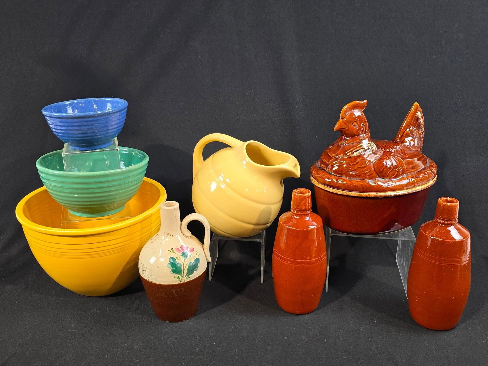 8 Mid Century and Modern Ceramics: Includes Hull, Fiesta, and more. Some chips to rims but overall good condition. Largest bowl 11" diameter. Ceramic bottles 9-1/4" tall.
