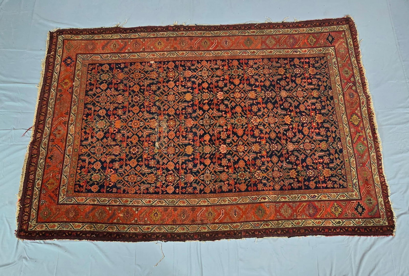 Antique Persian Rug: NOT ELIGIBLE FOR IN-HOUSE SHIPPING. 80" x 53". Damage to tassels and slight wear spot in middle. Overall good condition.
