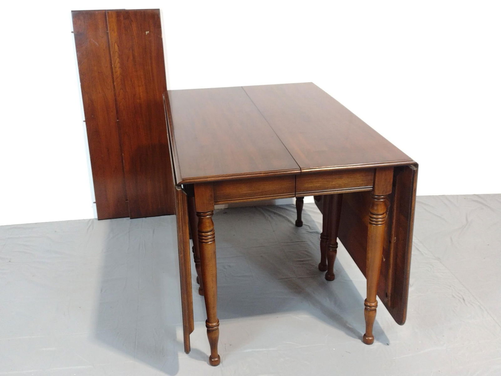 Drop Leaf Table: NOT ELIGIBLE FOR IN-HOUSE SHIPPING. Closed 29", open 77" wide X 41-1/2" deep X 29-1/4" high. Has some light scratches and finish loss. Two leaves each 10" wide.