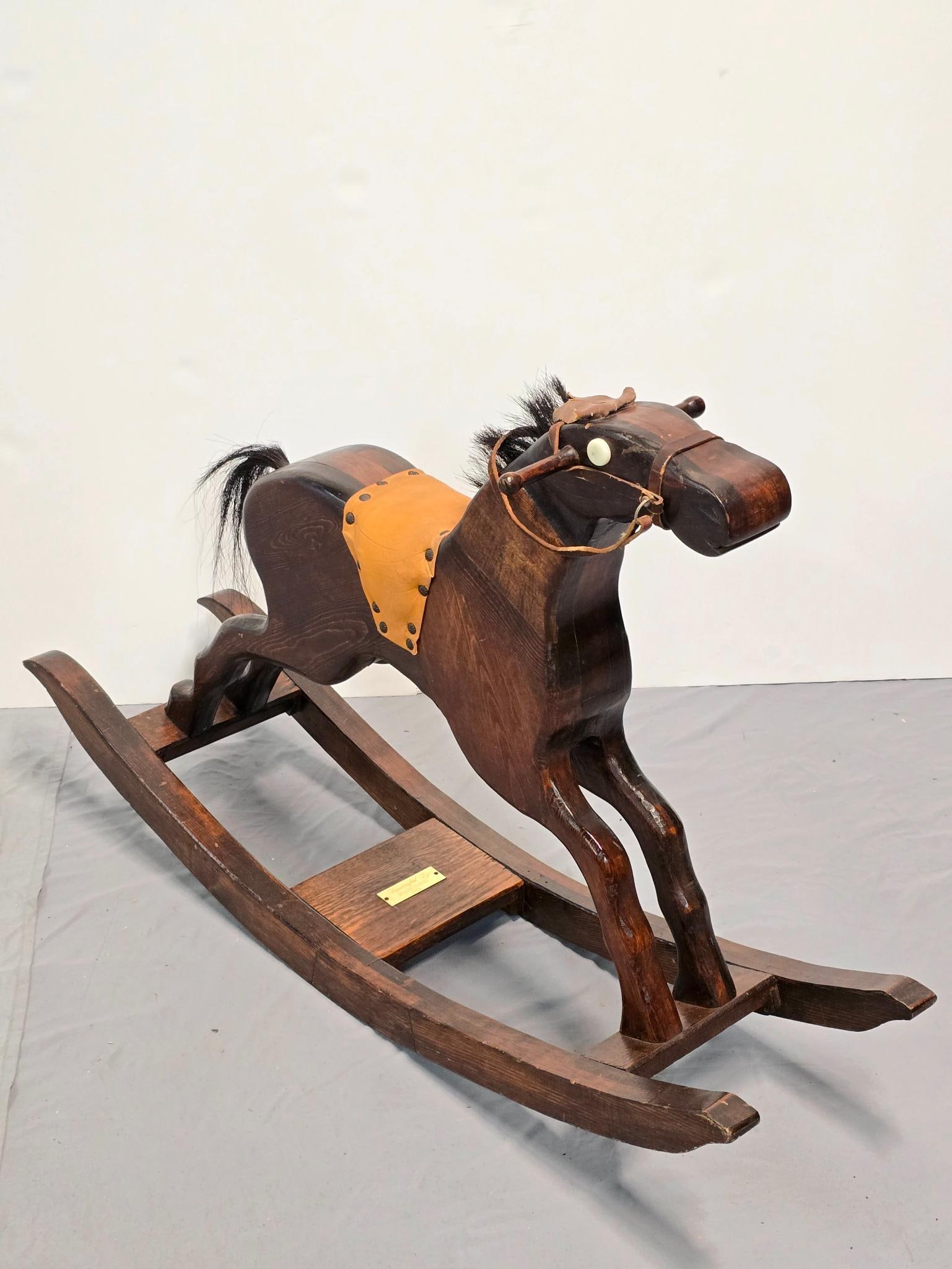 Handcrafted Wood Rocking Horse: NOT ELIGIBLE FOR IN-HOUSE SHIPPING. 11" wide x 42-1/2" long x 27" high. Plaque reads "Handcrafted by Adolph Florig 1986".