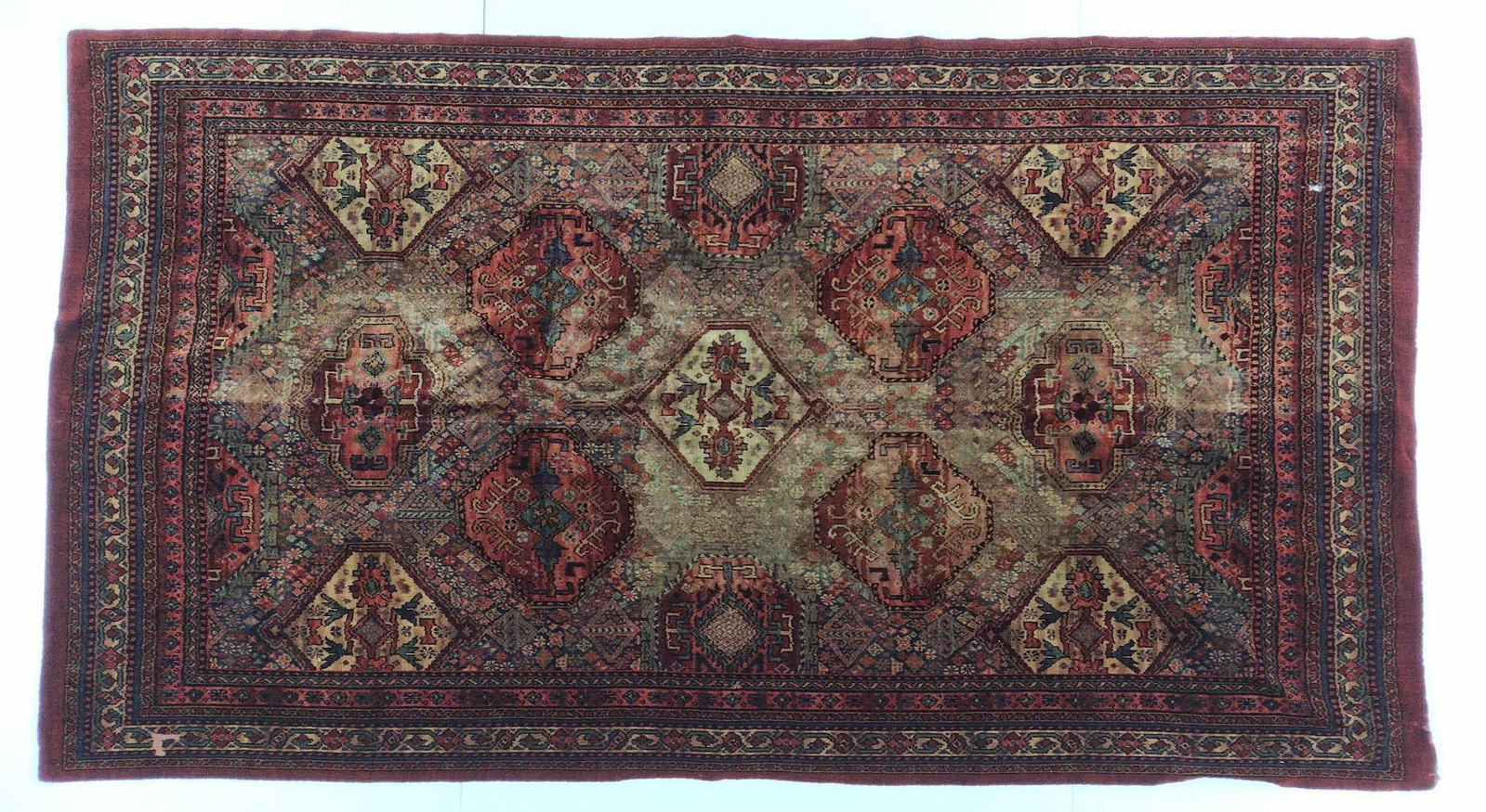 Vintage Persian Oriental Rug: NOT ELIGIBLE FOR IN-HOUSE SHIPPING. 109" x 60". Some fading, and a couple small holes, but overall good condition.