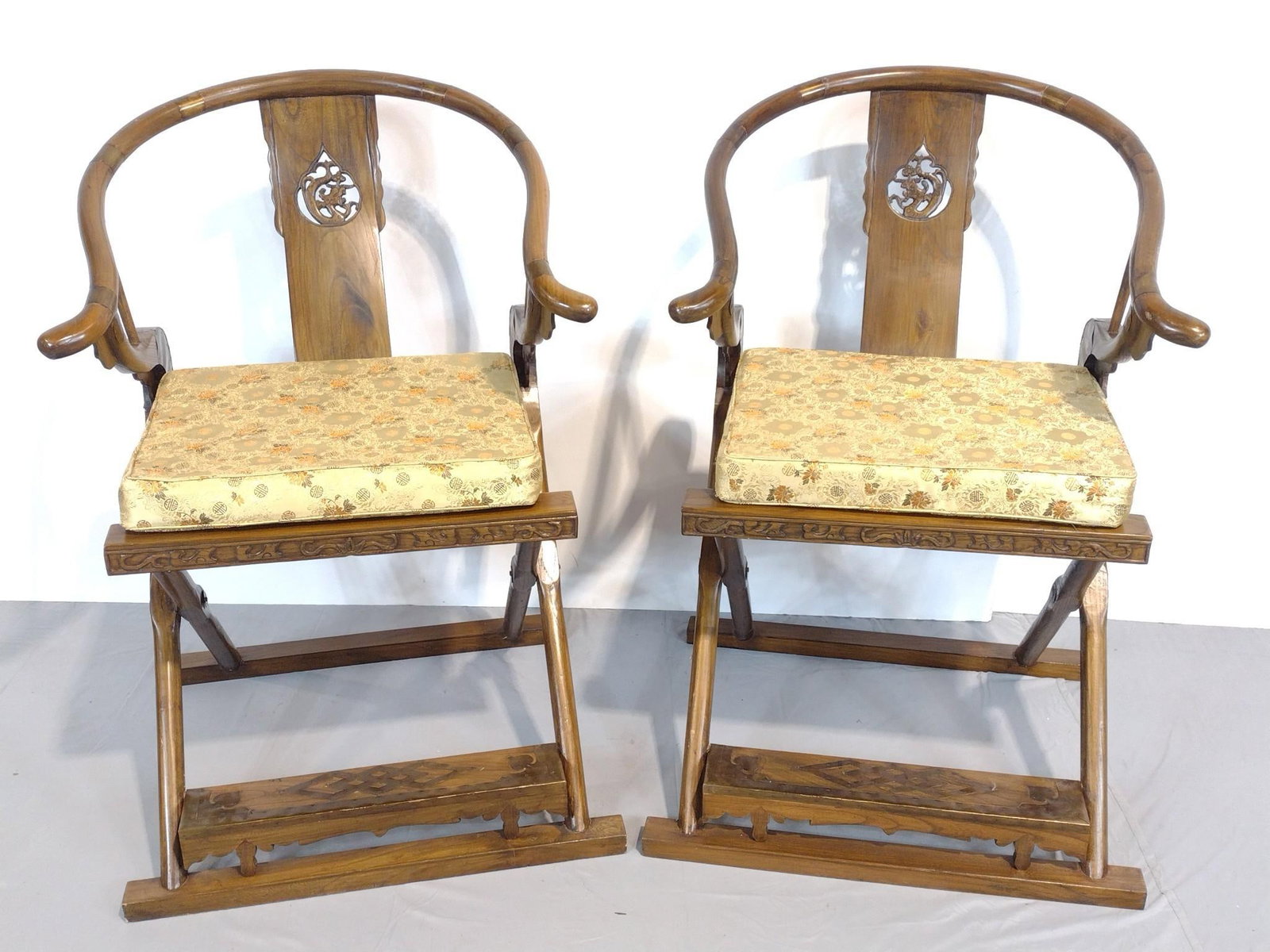 Pair of Asian Folding Chairs with Brass Accents: NOT ELIGIBLE FOR IN-HOUSE SHIPPING. Each 27" wide X 23-1/2" deep X 40" high.