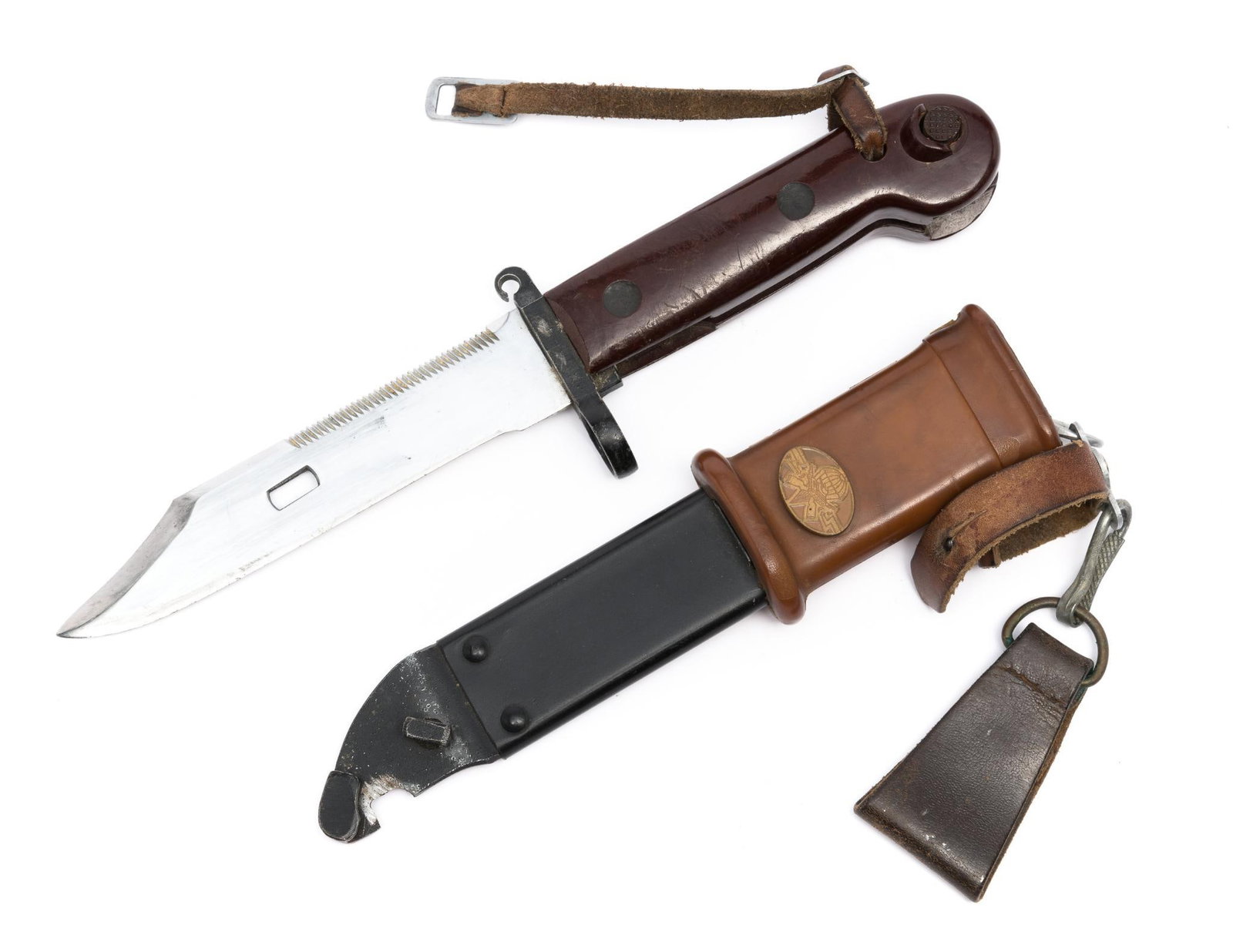Desert Storm/Iraqi AK47 Bayonet w/ Scabbard: DESCRIPTION: Wood handle. Emblem on scabbard. MEASUREMENT: Overall with scabbard 13-1/4" long. CONDITION: Wear to handle.
