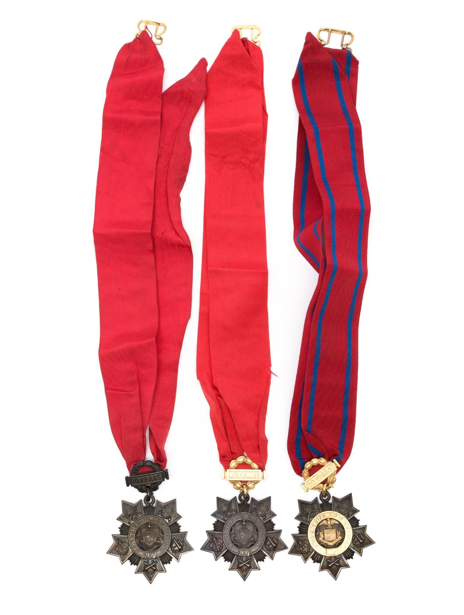 3 World War I National Guard Tiffany & Co. Ribbon Medals: DESCRIPTION: Includes 1) "10 Years Faithful Service NY" Medal on solid red ribbon, marked Tiffany & Co on reverse; 2) "15 Years Faithful Service NY" Medal on solid red ribbon, marked Tiffany & Co on r