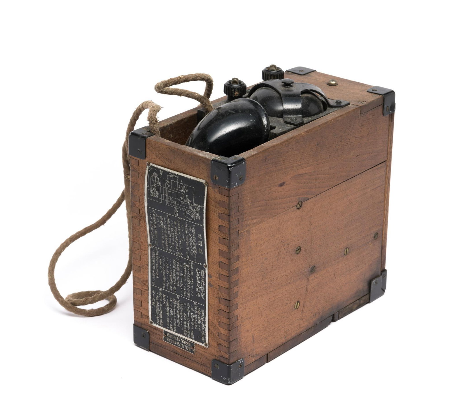 WWII Japanese Field Telephone: DESCRIPTION: Japanese field telephone with instruction plaque on outside. MEASUREMENTS: 8-1/2" wide x 4" deep x 9-1/2" high. CONDITION: Some cracks to wood. Wear to phone finish.