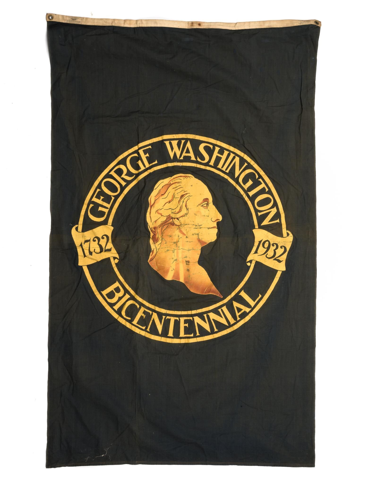 George Washington Bicentennial Flag: DESCRIPTION: Flag celebrating the 200th anniversary of the birth of George Washington. Tag marked "Batfast Sheeting." MEASUREMENT: 2' 10" wide x 4' 9" long. CONDITION: Small hole near top of head.