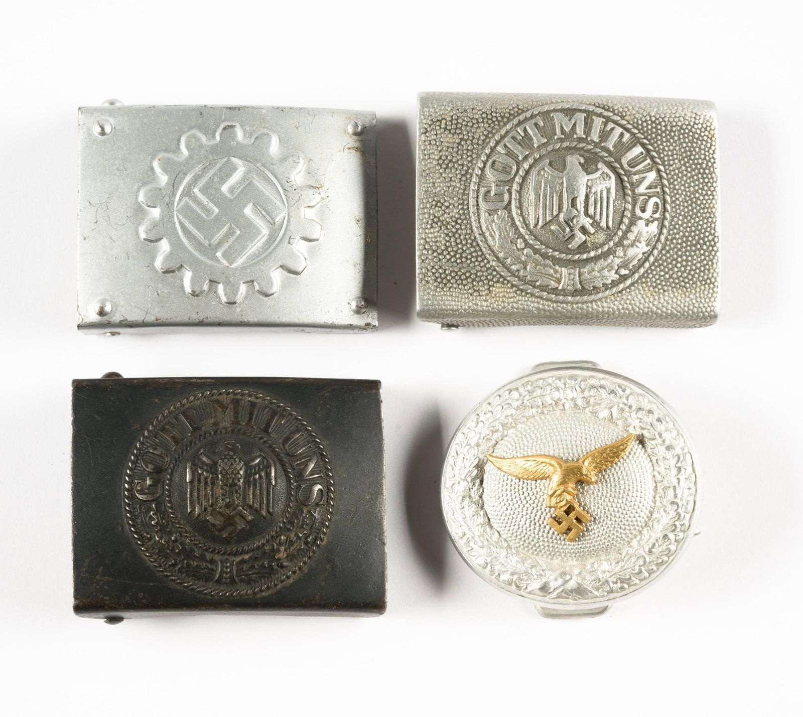 4 World War II German Army Buckles & German Air Force Officer Buckle: DESCRIPTION: (2) German Army Heer Buckles; German Air Force Officer Buckle with golden eagle on silver alluminum backing. Also includes DAF enlisted belt buckle. All four have numbers, letters, and lo
