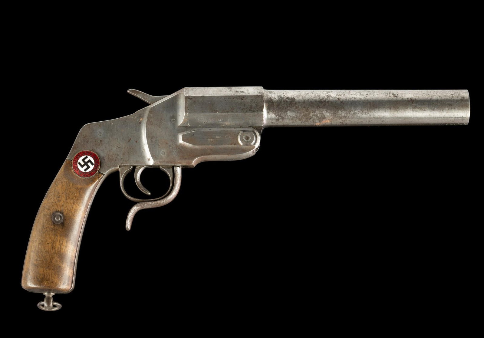 German Flare Pistol, About 1 1/16" bore: Serial Number: 2650 Design: This German flare pistol has a 9" barrel with a bore diameter of about 1 1/16". An empty flare shell is in the barrel. Wood grips. This piece is in the white with some pati