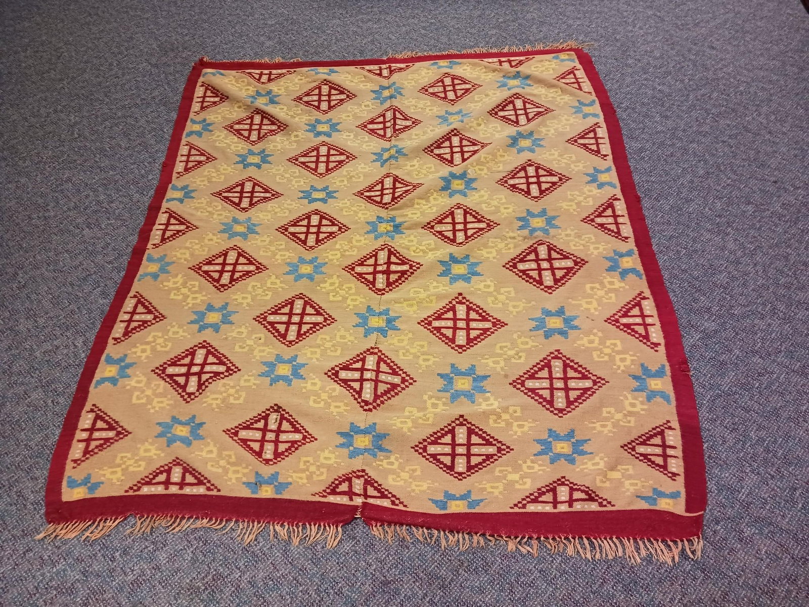Geometric Coverlet: 5' wide x 8' 3-1/4" long. Losses to edges. Repair to one edge. Center with some separation.