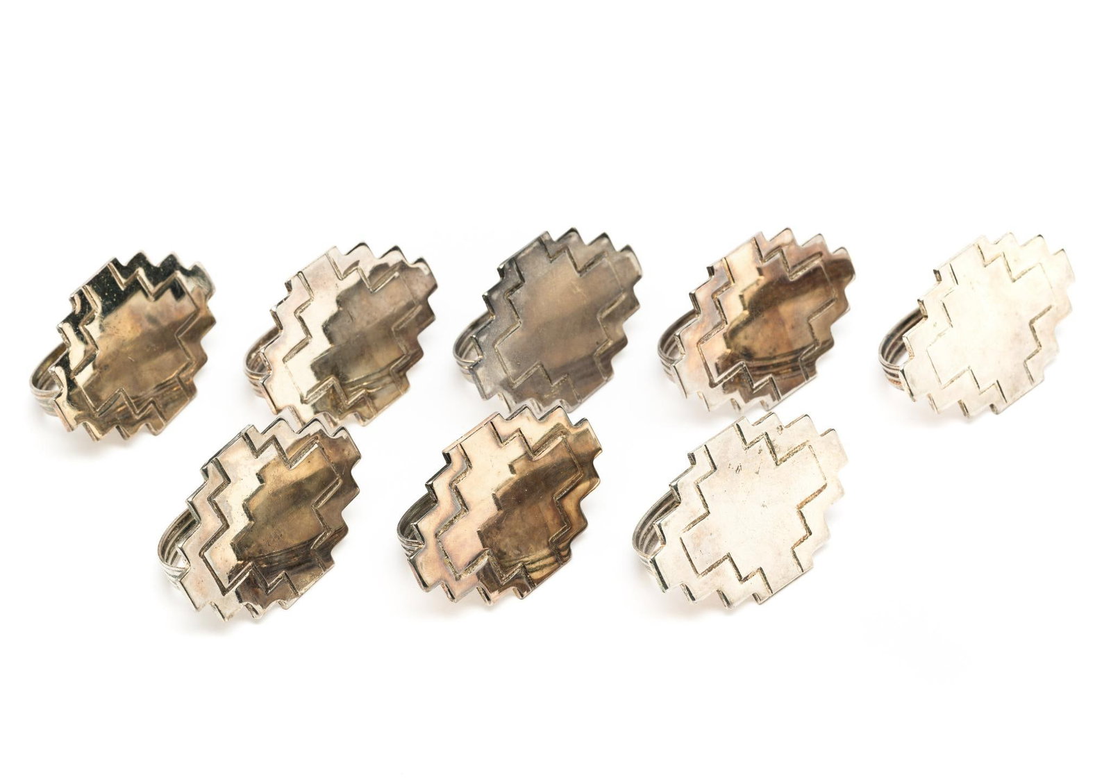 8 Napkin Rings: 1-5/8" wide x 2-1/4" long. Some tarnishing.