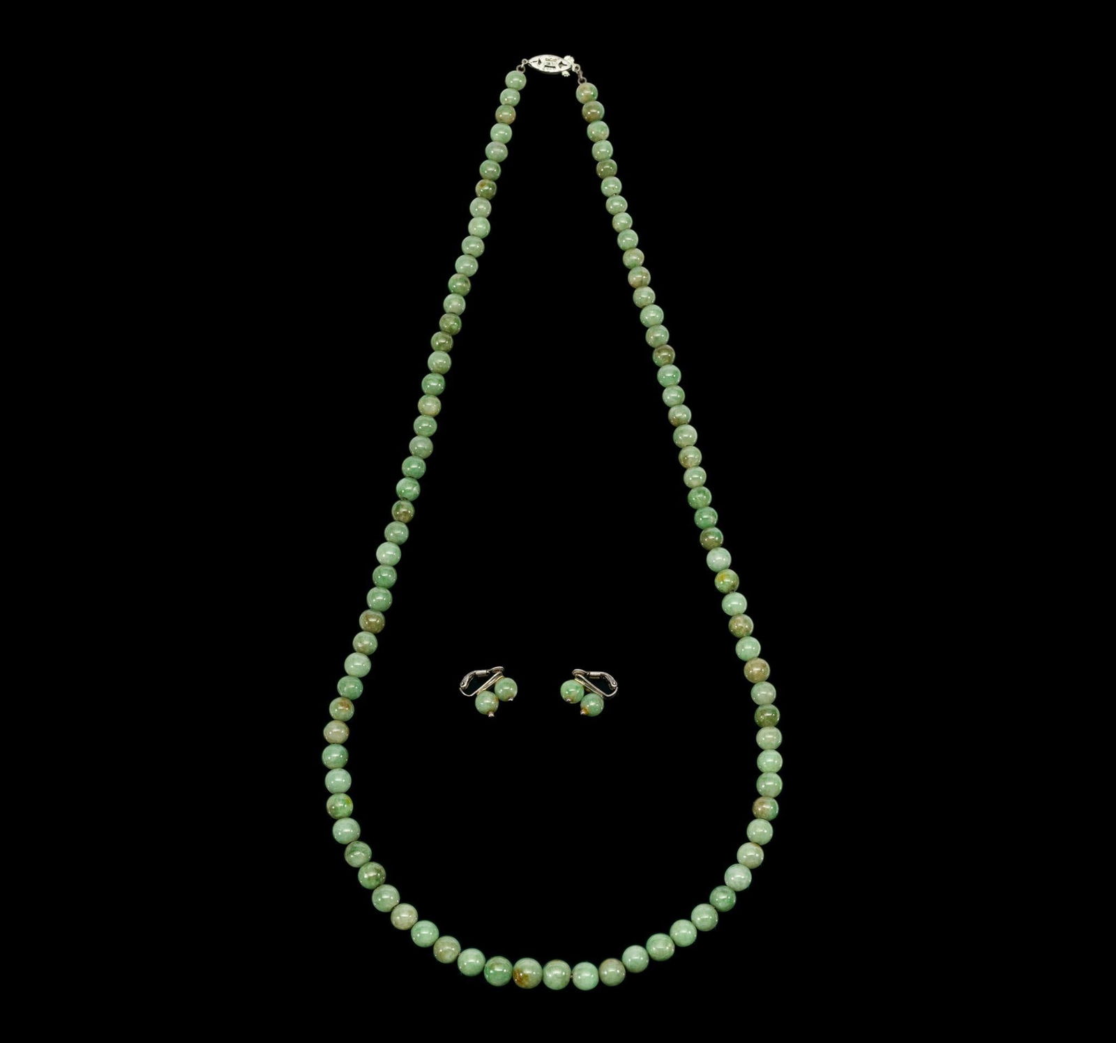 Jade Bead Necklace And Earings: 28" necklace with untreated nephrite jade beads. Beads are 6 to 9 mm diameter. A matching pair of clip-back earrings comes with the necklace. The hardwear is sterling silver for both. Beads are Mid-ce