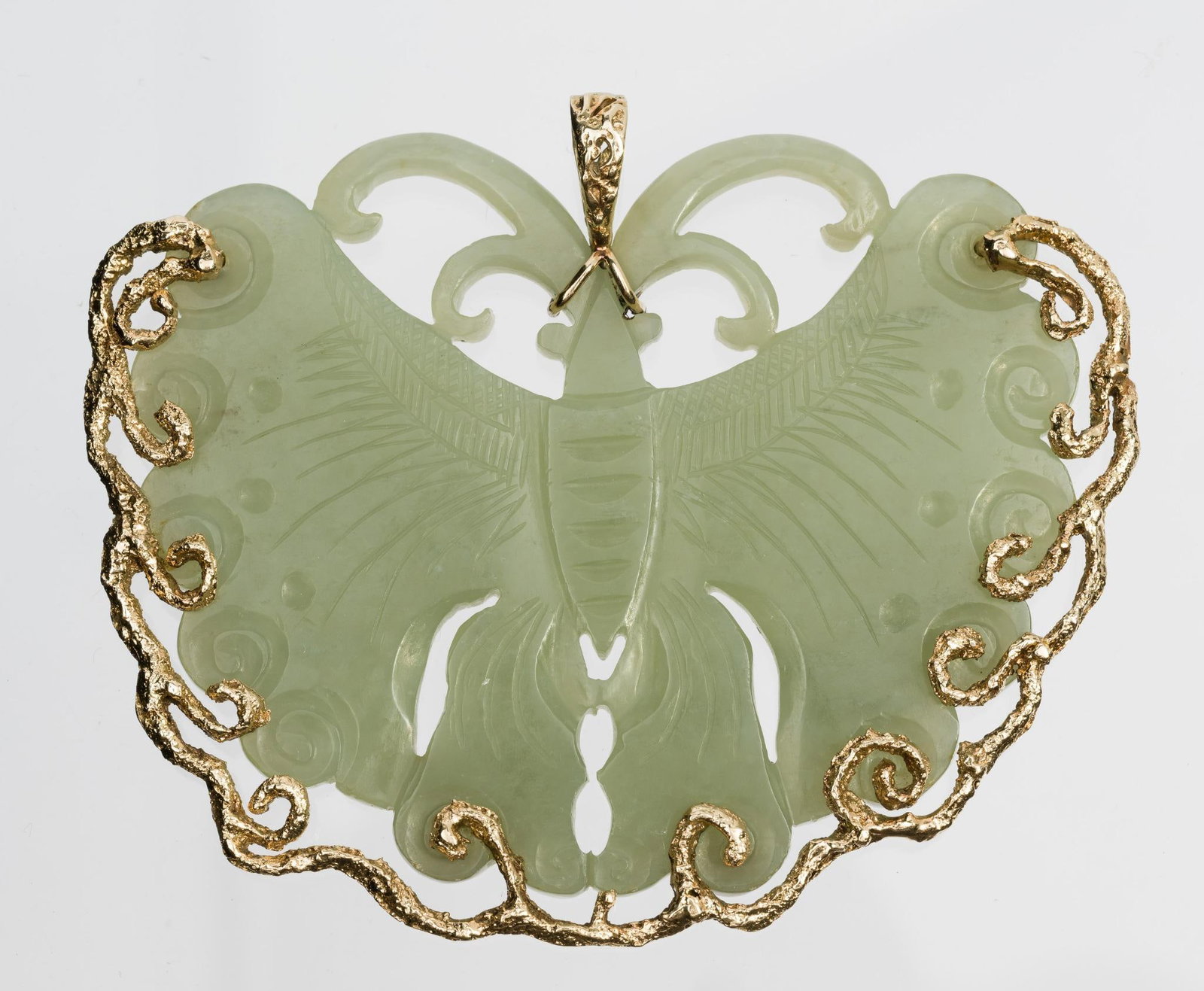 Chinese Qing Dynasty 14K Gold & Carved Jade Butterfly Pendant: Carved jade butterfly pendant set in unmarked gold decoration and bail, tests 14k gold. 2-7/8" x 3-1/2".
