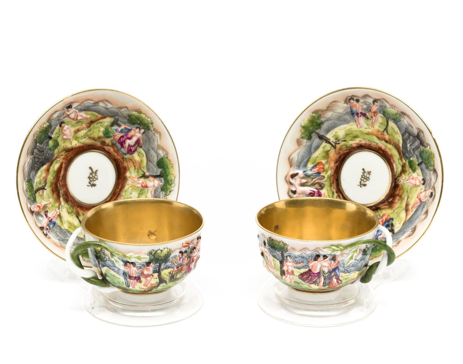2 Capodimonte Tea Cups & Saucers: DESCRIPTION: Both marked with Royal Palace of Naples mark. Saucer with floral mark in center. Gold on inside of cup. Roman scene on cup and saucer. MEASUREMENT: Cups measure 3-1/8" wide x 2" high. Sau