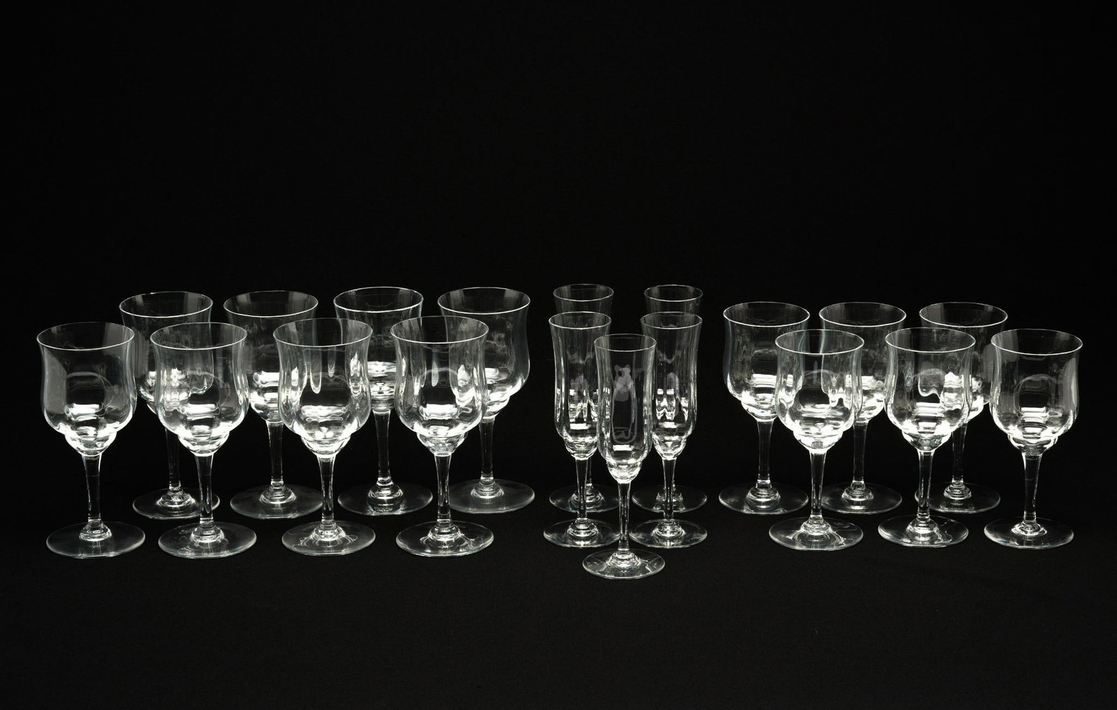 19 Pieces of Baccarat 'Capri' Stemware: DESCRIPTION: Includes 5 fluted champagne glasses, 6 claret wine glasses, and 8 tall water goblets. All marked on bottom. MEASUREMENTS: Fluted champagne glasses measure 2-1/8" wide x 7-1/4" high. Clare