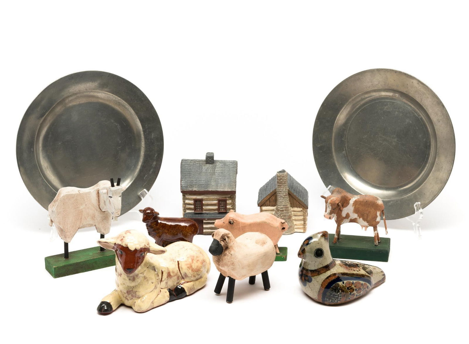 13 Household Decorations and Pewter: Includes (2) pewter plates, (2) miniature log cabins, (1) paint decorated stoneware bird, (4) wood carved animals, and (2) redware animals. 3-1/2" to 6-3/4" high. Pewter plates: 9-1/4" diameter.