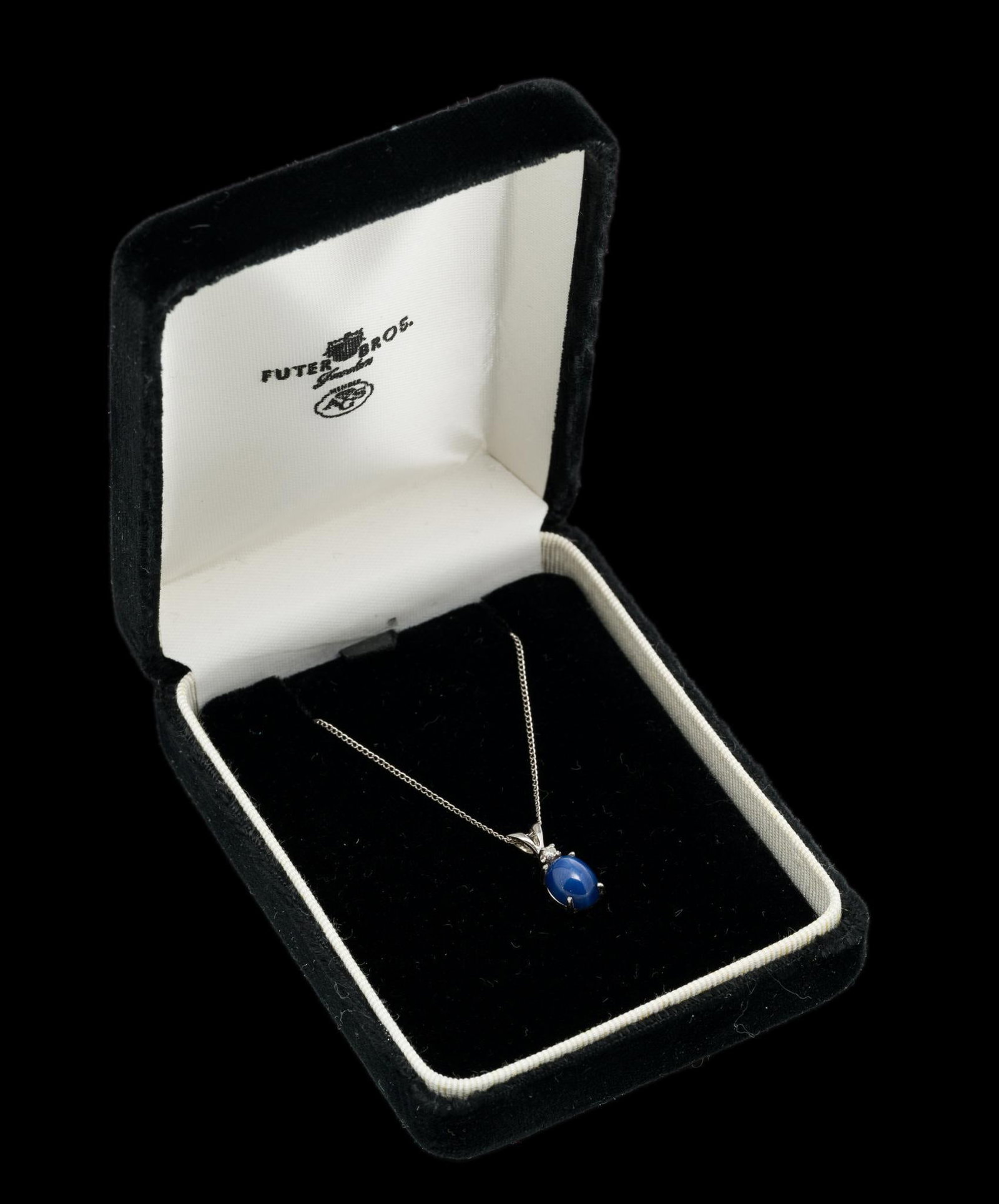 14K Gold, Blue Star Sapphire & Diamond Pendant Necklace: Tested 14k white gold pendant set with blue star sapphire and diamond, 3/4" high. On marked 14k white gold chain, 18" long. 2.1 grams. Includes Futer Bros Jewelers necklace box. Box 3-3/4" x 2-3/4" x 