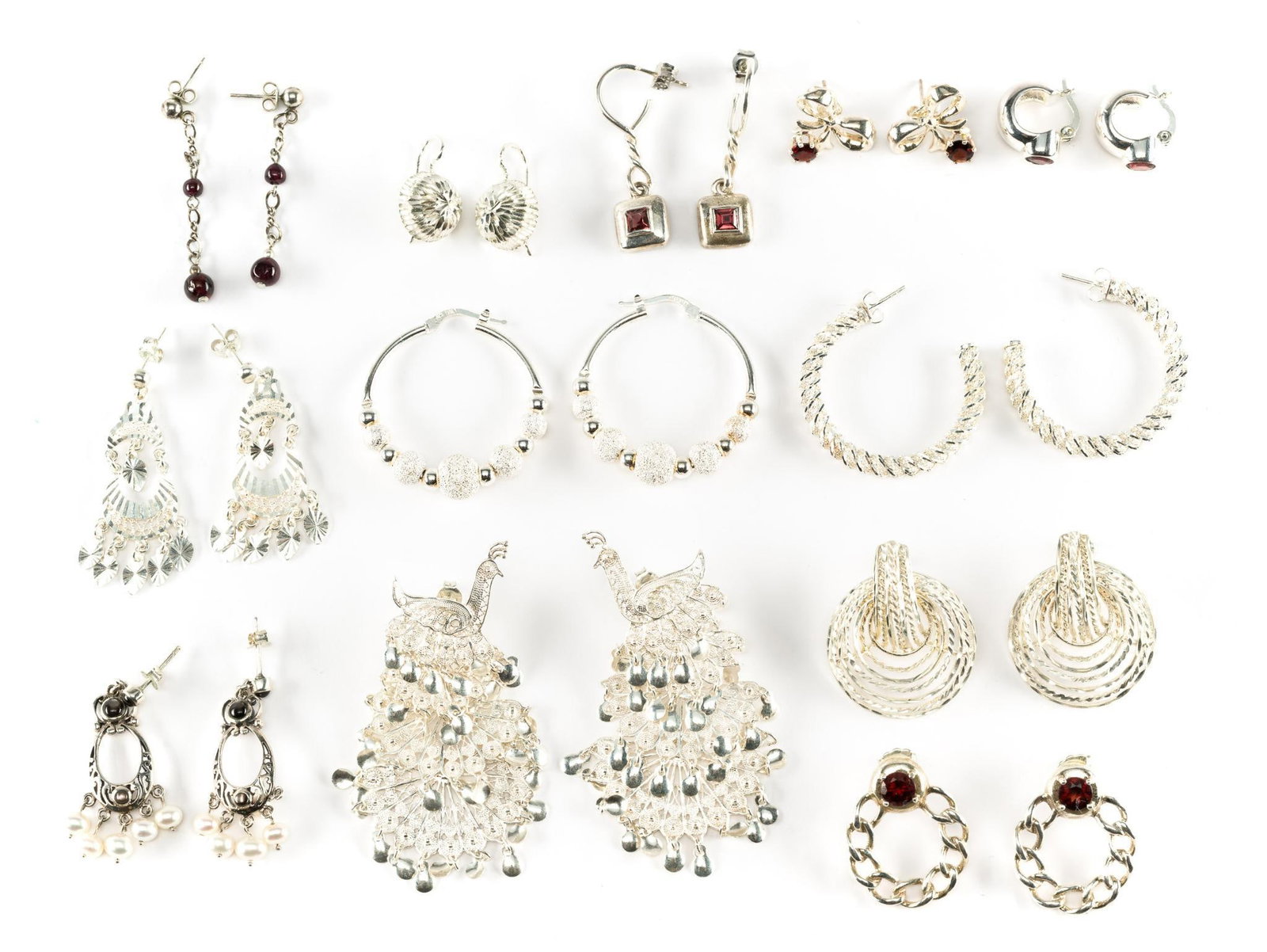 12 Pairs Sterling Silver Earrings: Includes Italy, peacock, hoops, garnet, and pearl. 5/8" to 2-5/8". All pierced.